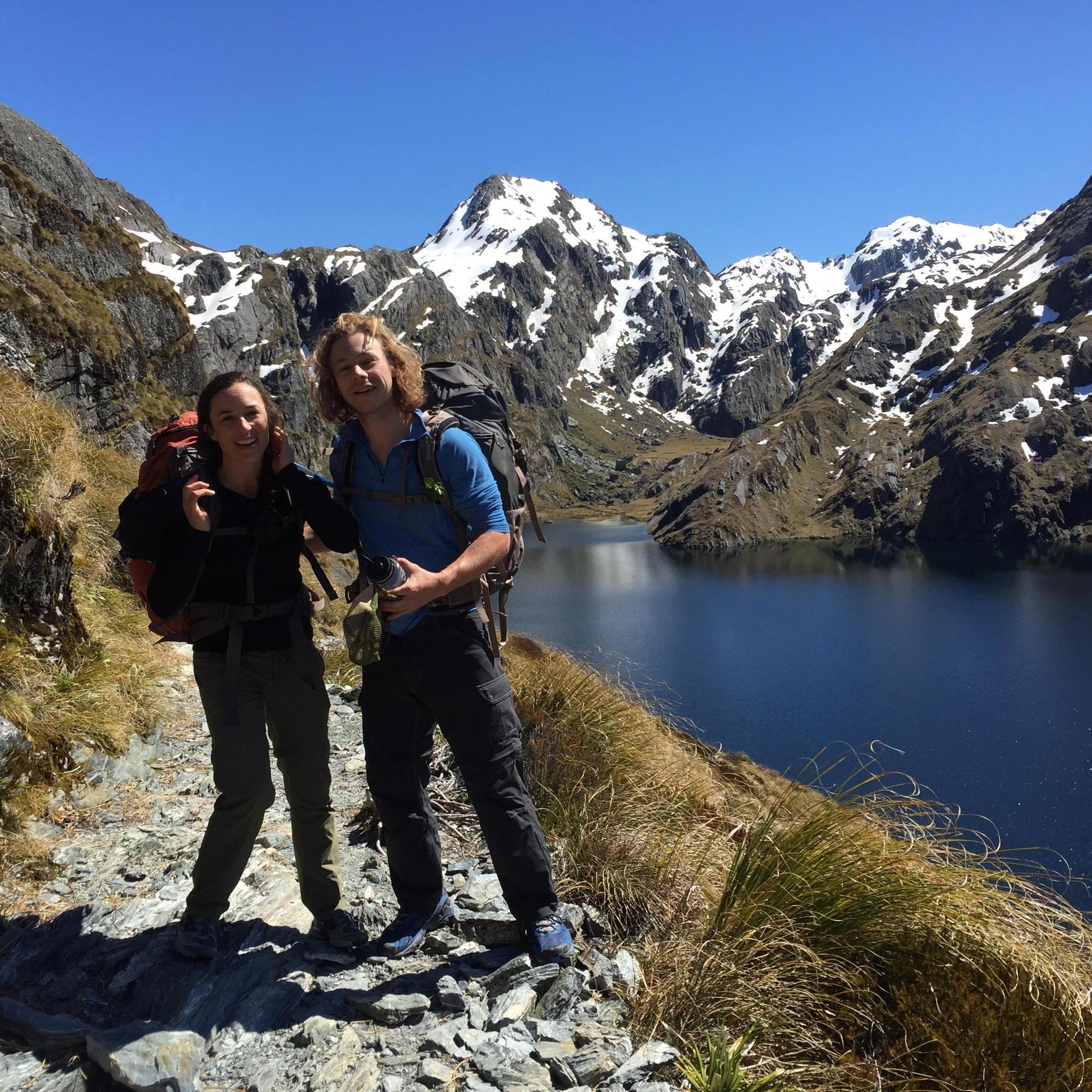 Scrambling to take our photo on the Routeburn Track in New Zealand.