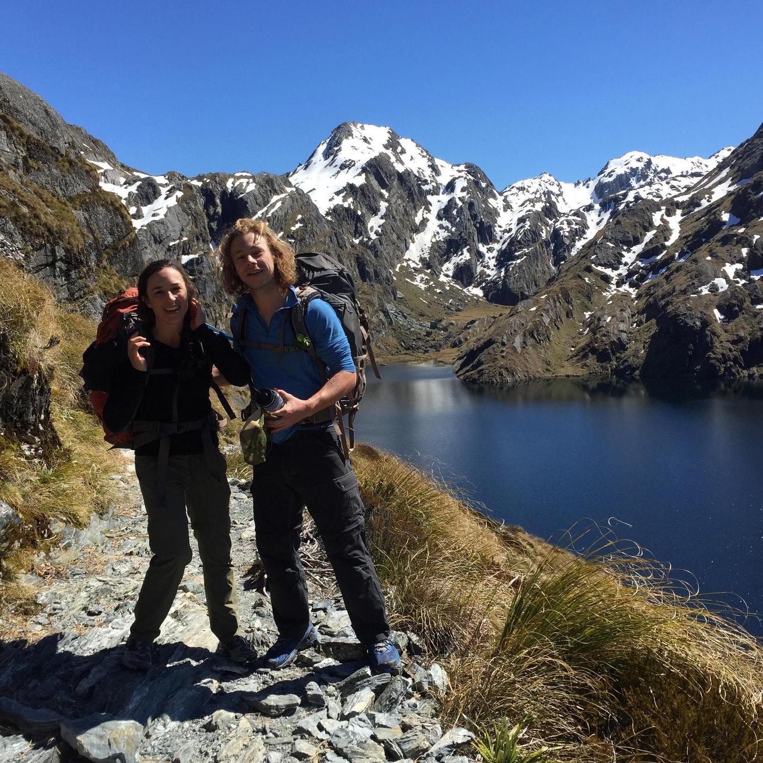 Scrambling to take our photo on the Routeburn Track in New Zealand.