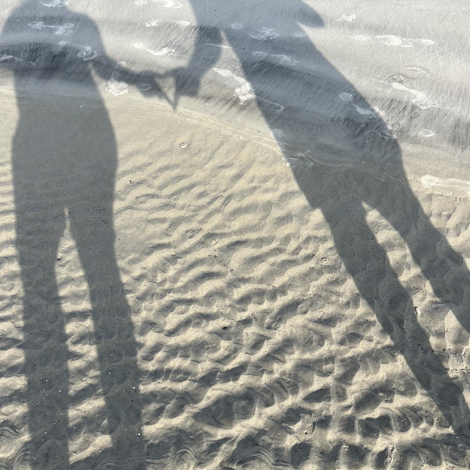 Us making shadows on Tybee sand dunes
