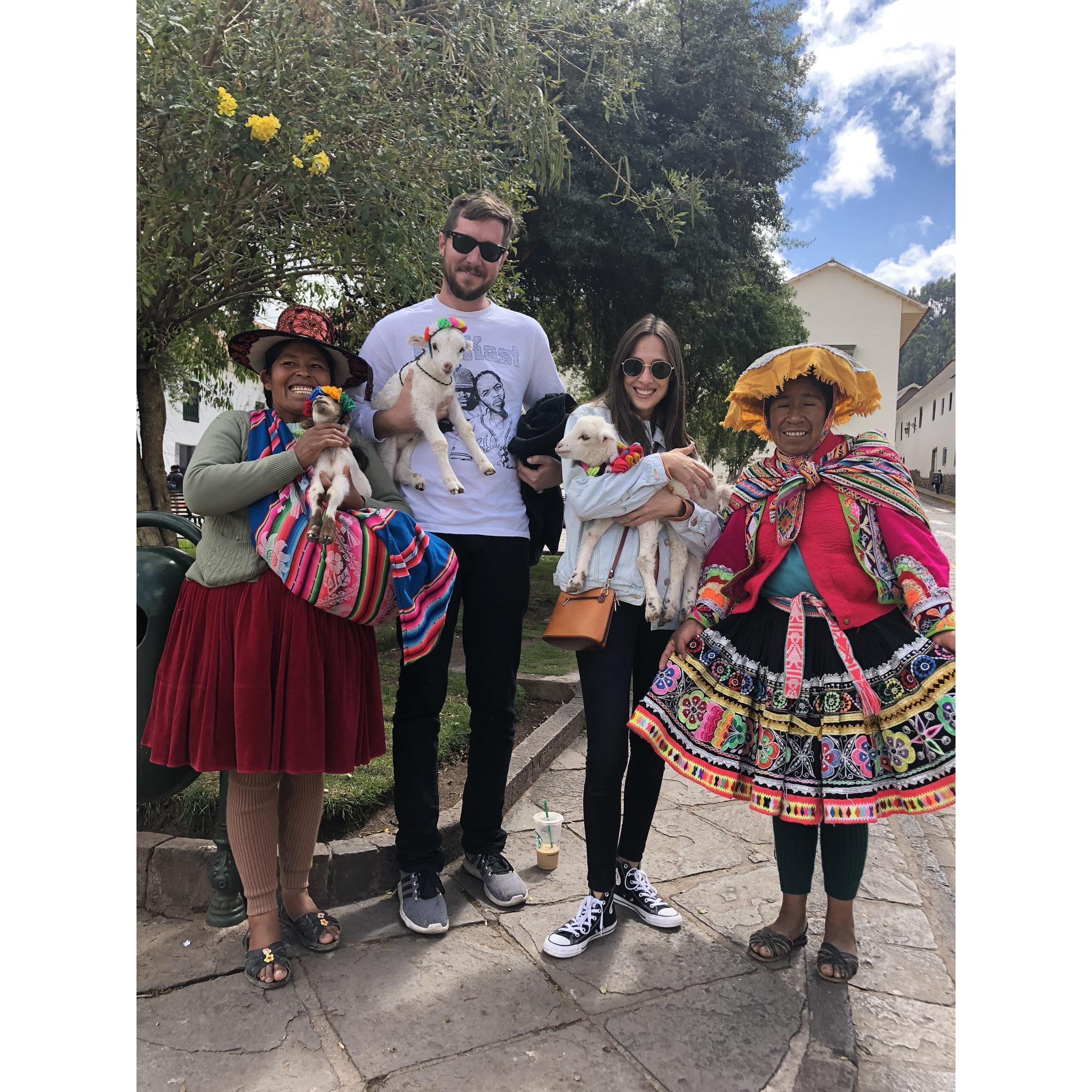 Devin and I holding baby sheep on the streets of Cusco, Peru.