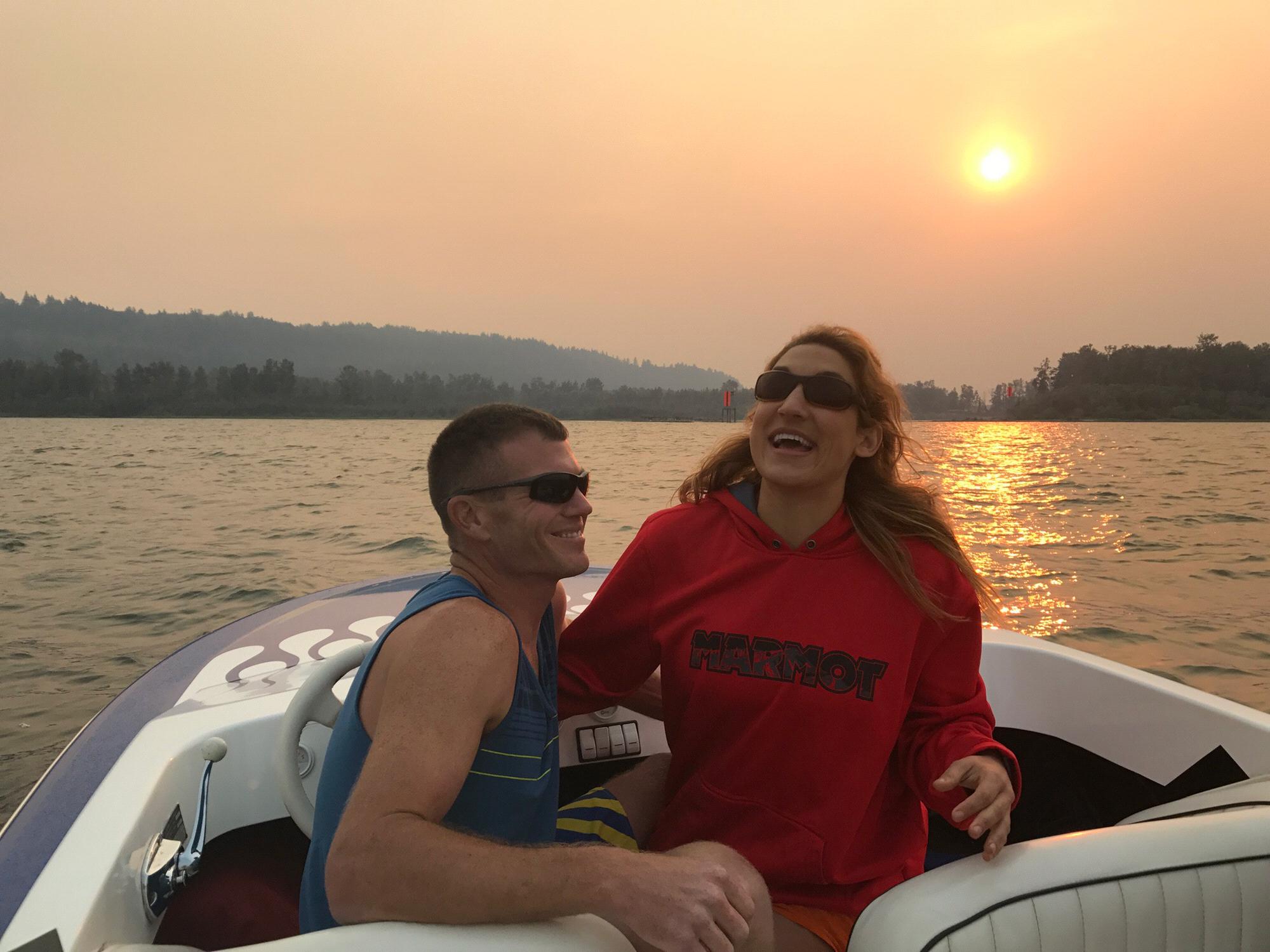 Tim making Lauren laugh on the Columbia river at sunset in the summer (2018?)
