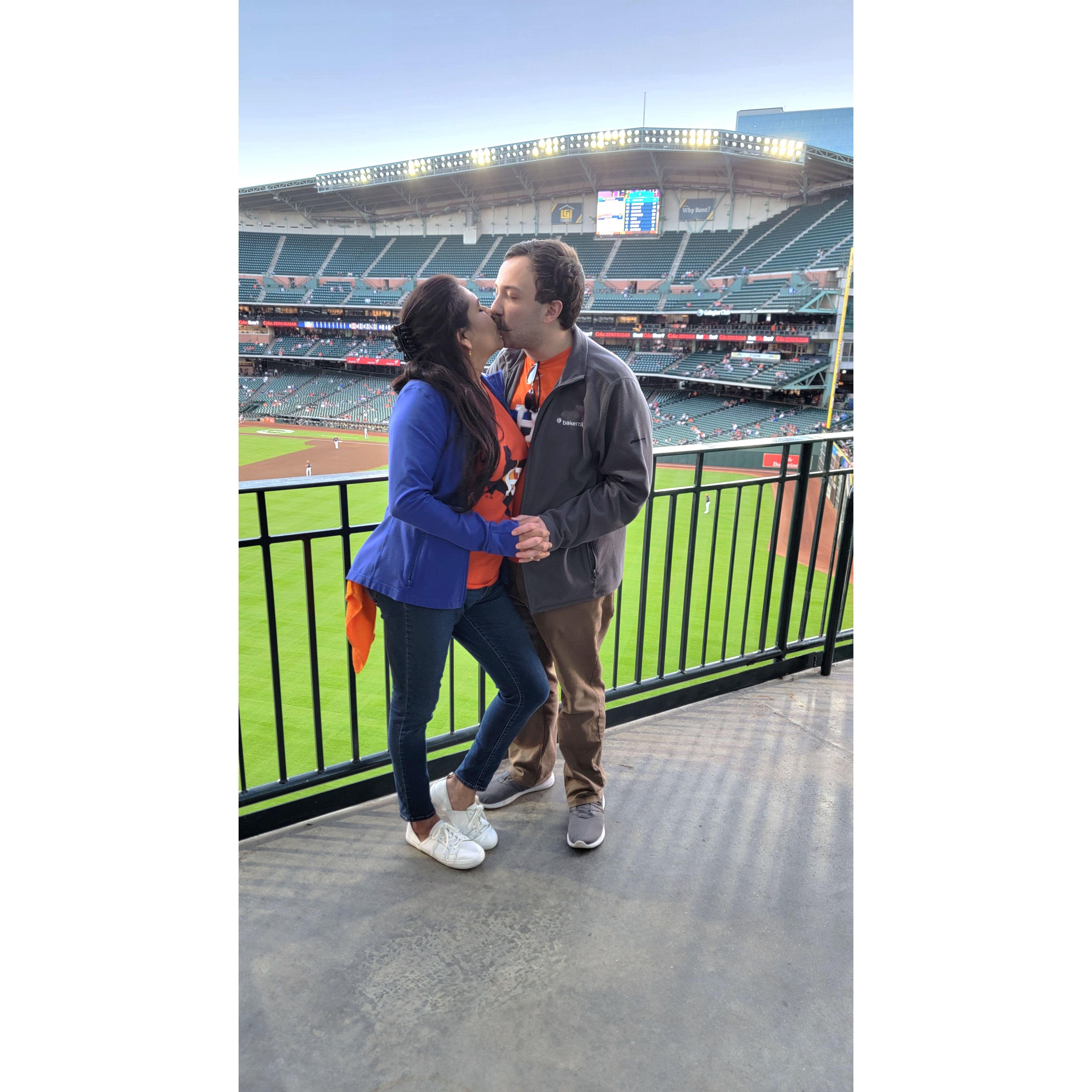 Miguel, Laura’s brother, captured this candid moment of us kissing with the outfield of Minute Maid Park as our backdrop during an Astros game, proving that love can steal a base and score a run!