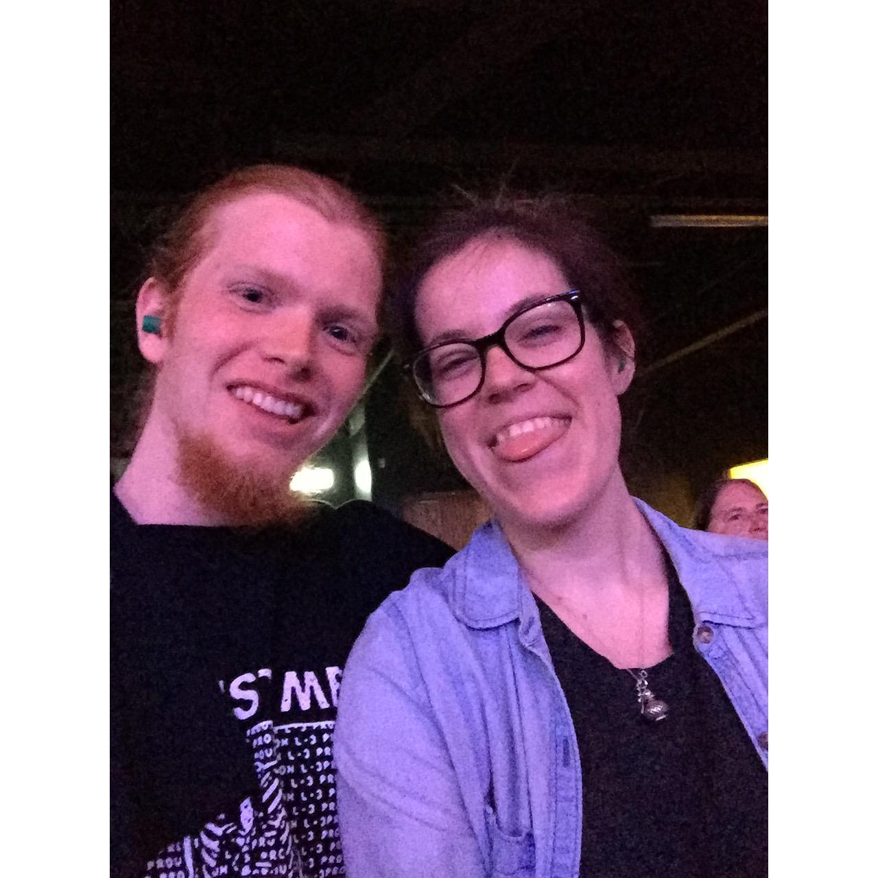 The first concert Rach & J.P. attended together - note the neon blue earplugs protruding from their ears.