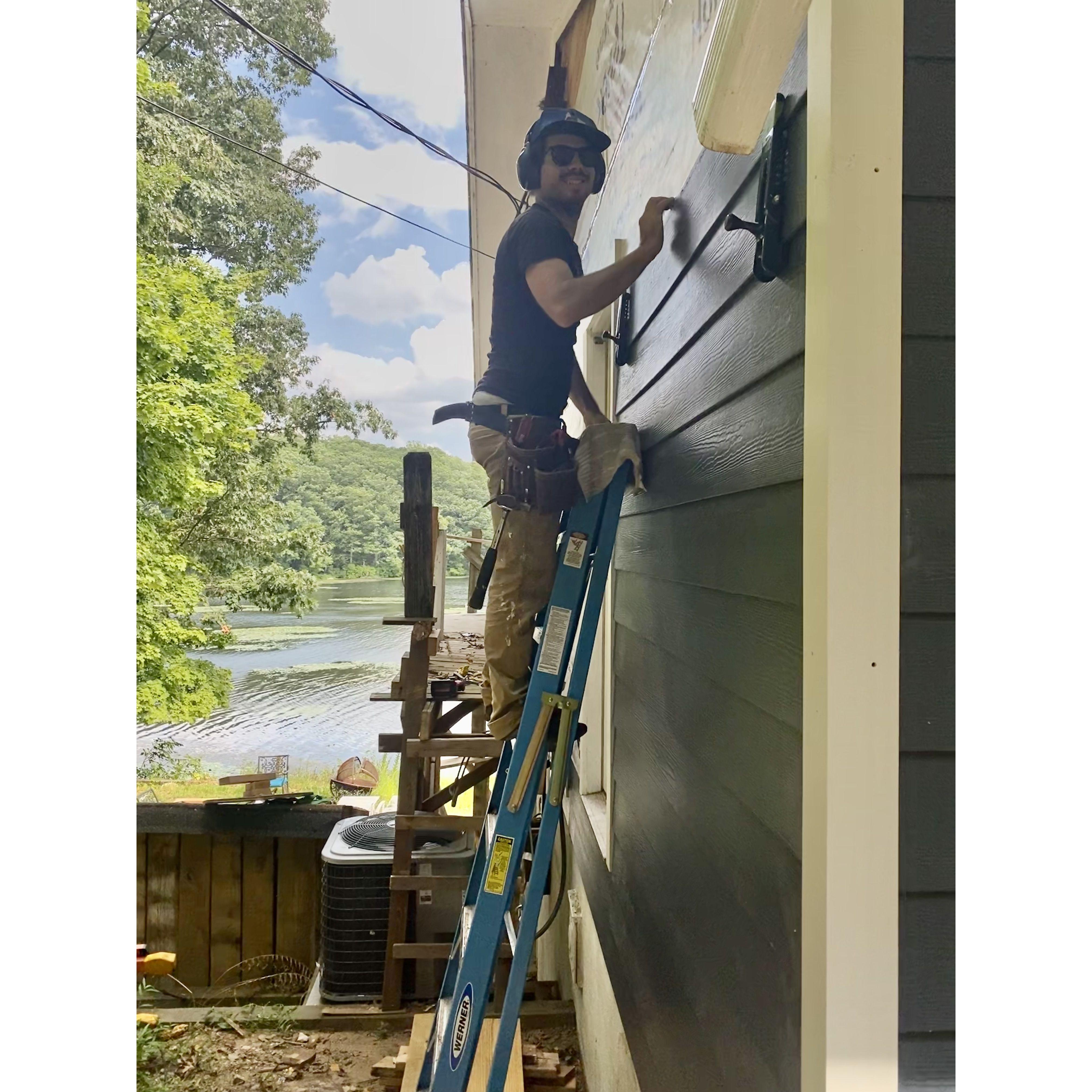 August 2022: Kevin working on re-siding the house