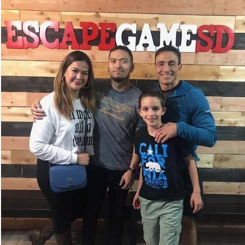 Our first ever photo was taken with a random father and son at Escape Game SD.
