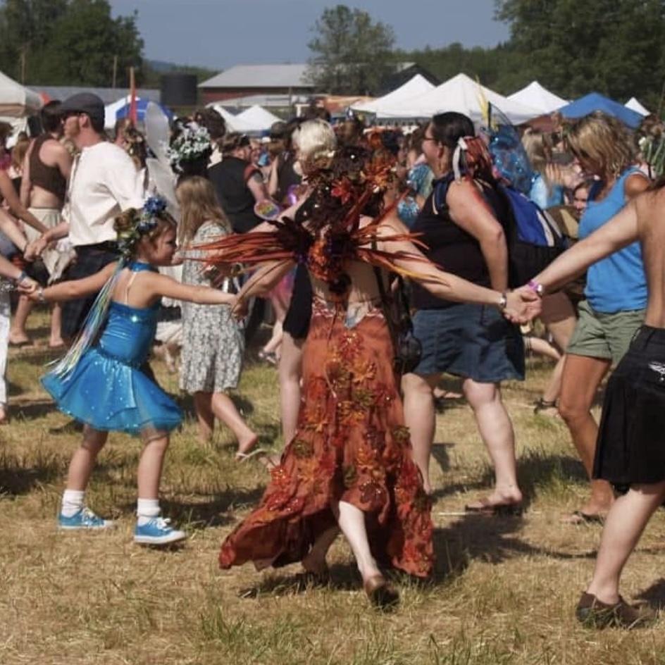 Summer spiral dance at Faerieworlds. The orange and black outfits would be perfect if it were summer.