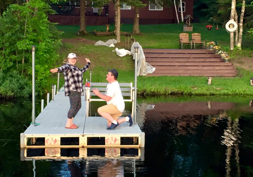 Re-creating Cory down on one knee from Corys grandparents cabin neighbors passing by on the pontoon