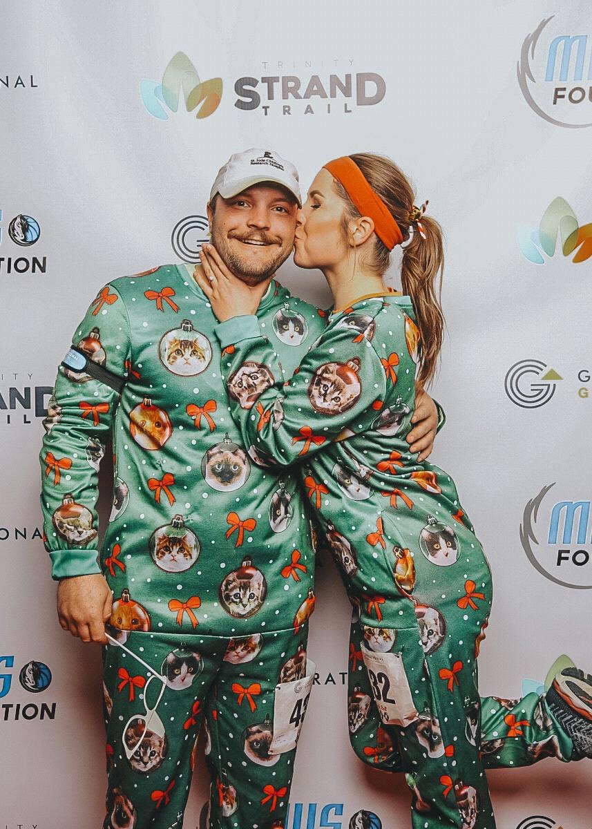 Nearing Christmas 2019, DJ and Katie ran a nighttime 5k in Dallas. Not the first time they wore these matching onesies.