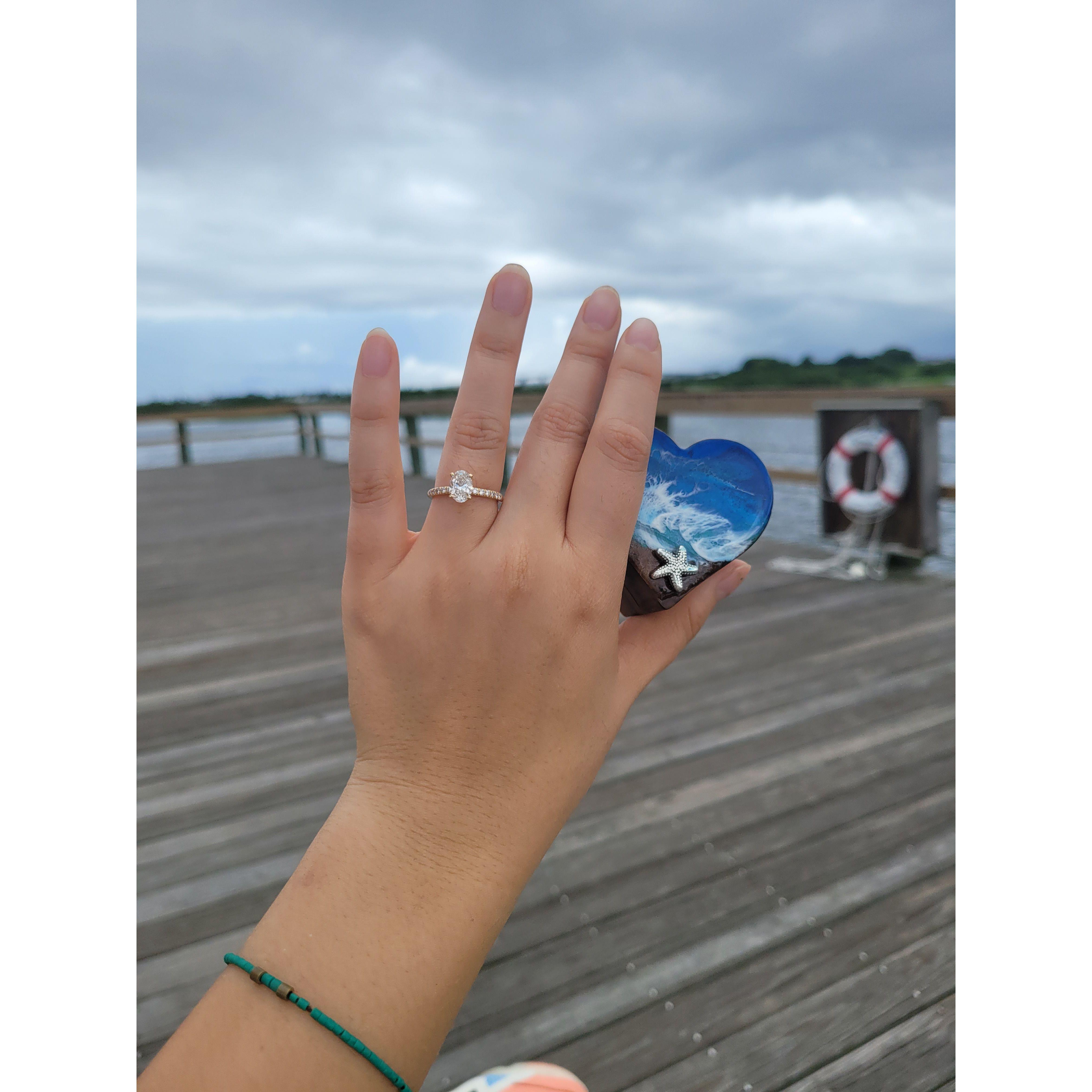 He proposed at the Seaside. Her favorite view! And a ring box of the beach waves, too!