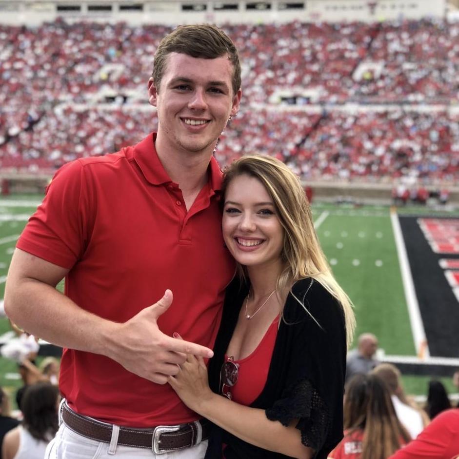 Marisa and Adam cheering on Tech football!