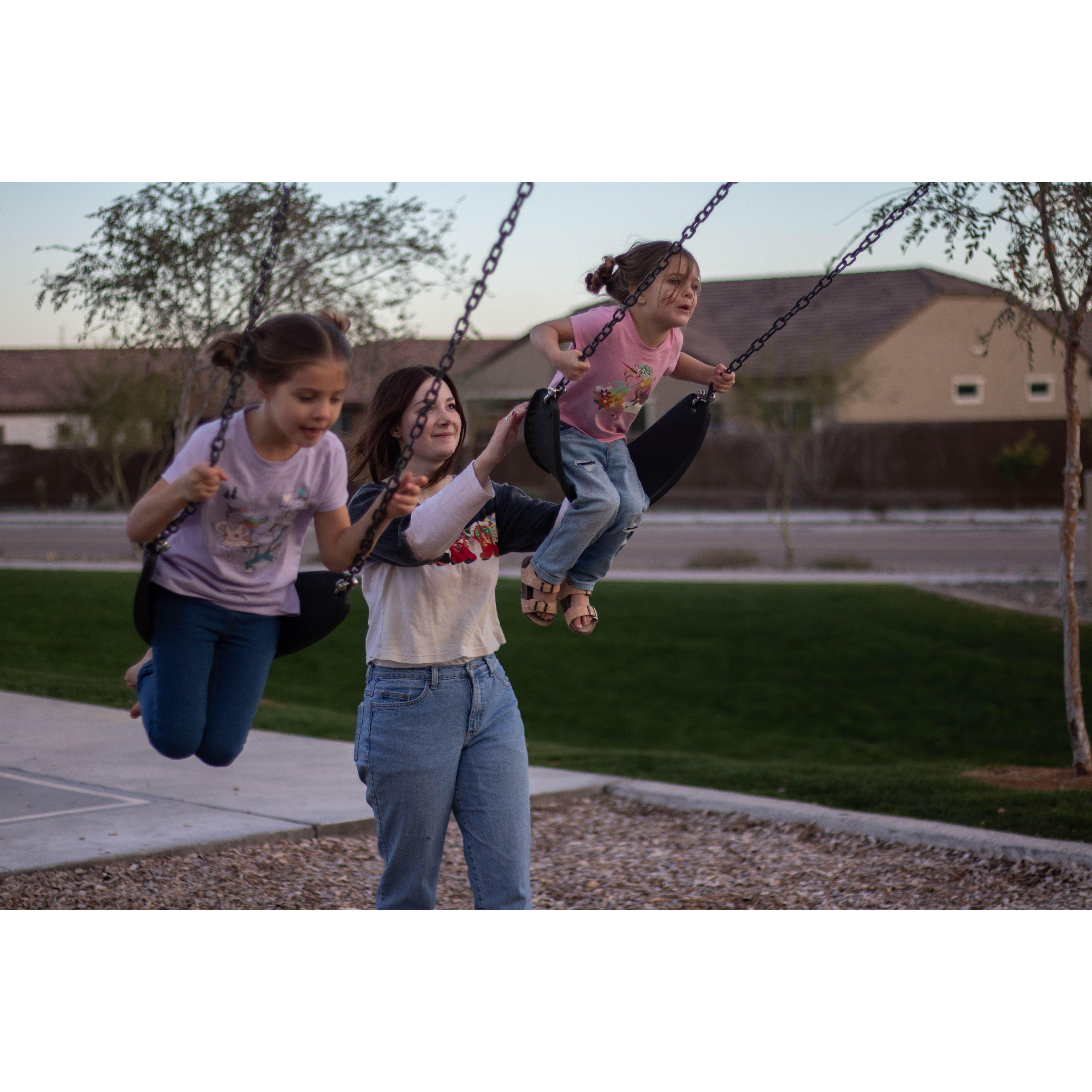 Emi Pushes Kohl's Sisters on the Swings