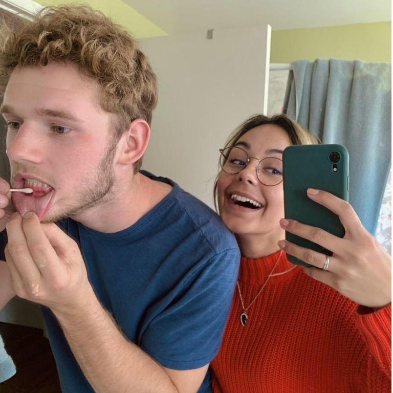 Luke putting hydrogen peroxide on a canker sore
