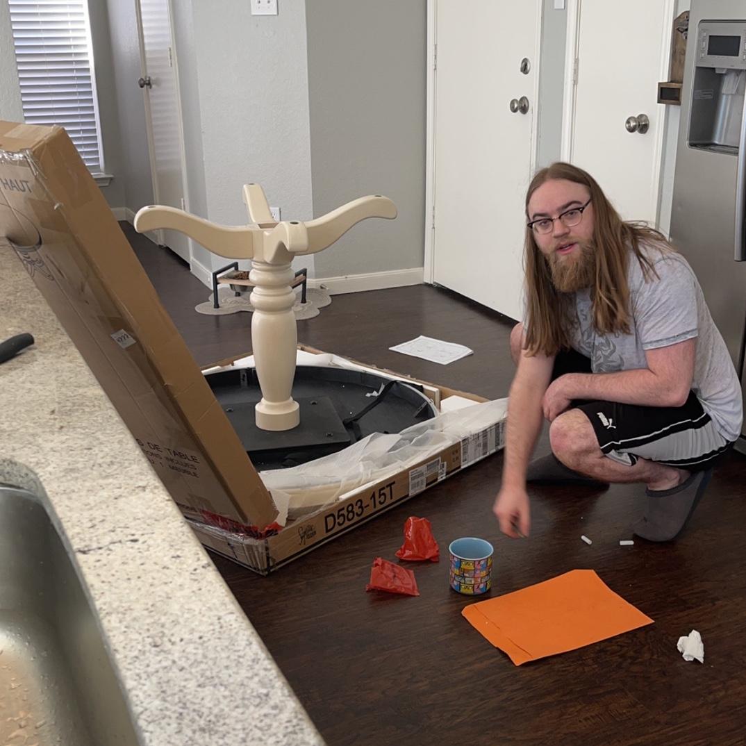 Bryce putting together our table when we moved into our first home together in September 2021!