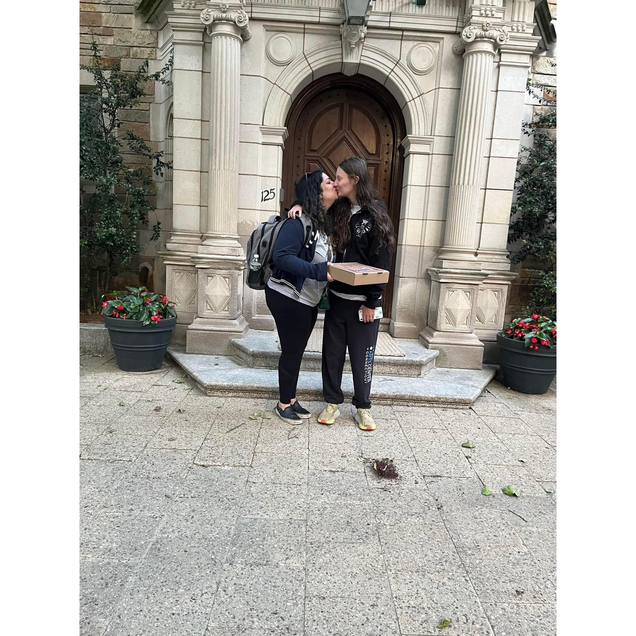 Kissing in front of a Yale University building after pizza night with friends
