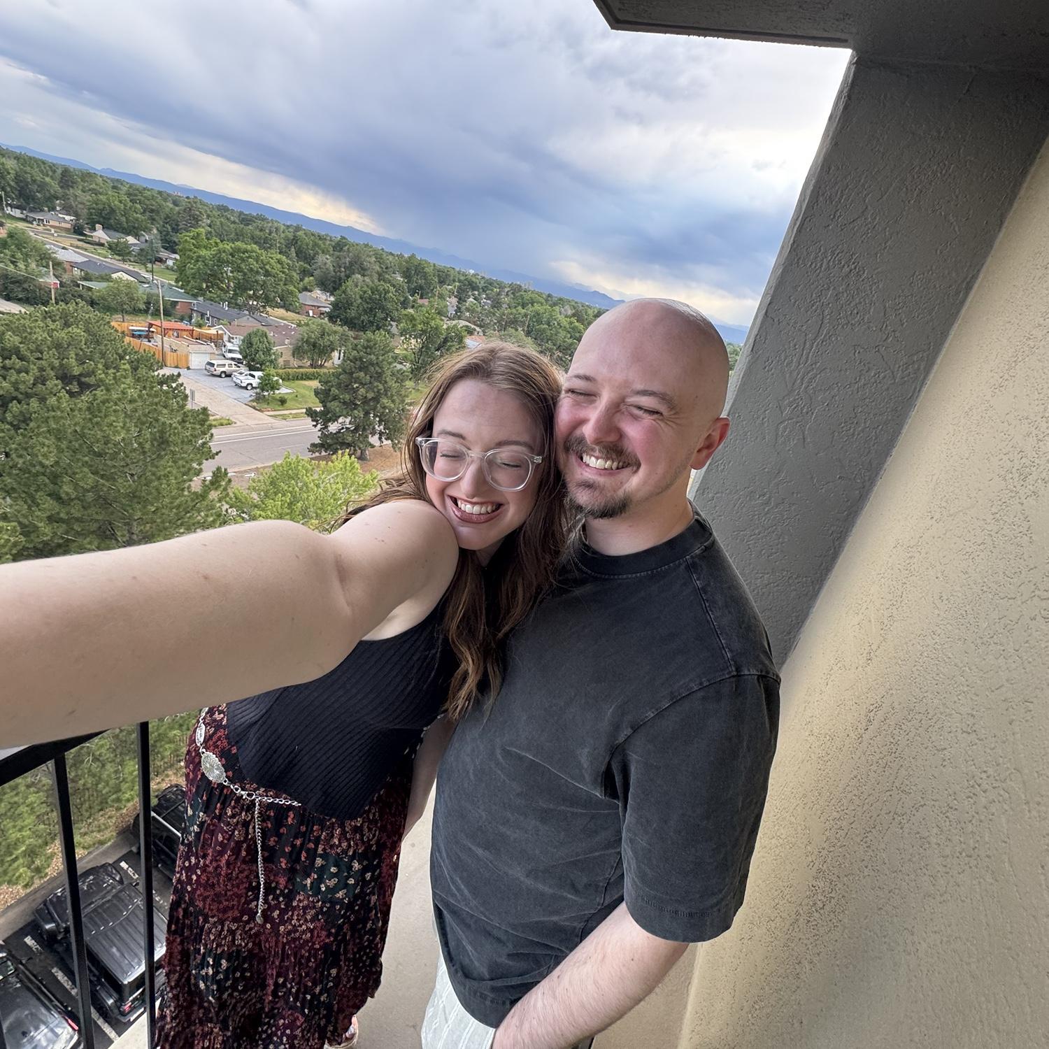 Cheesy smiles with Denver in the background