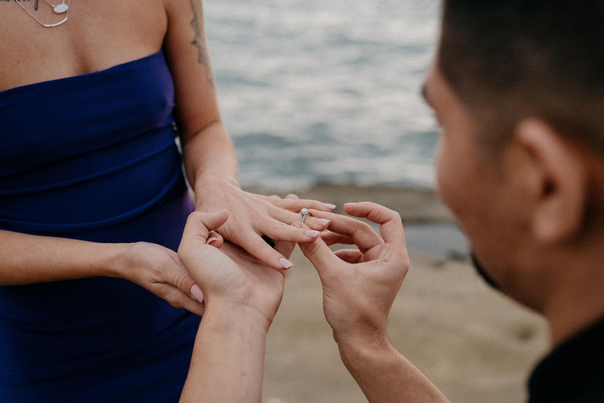 Putting on the engagement ring.