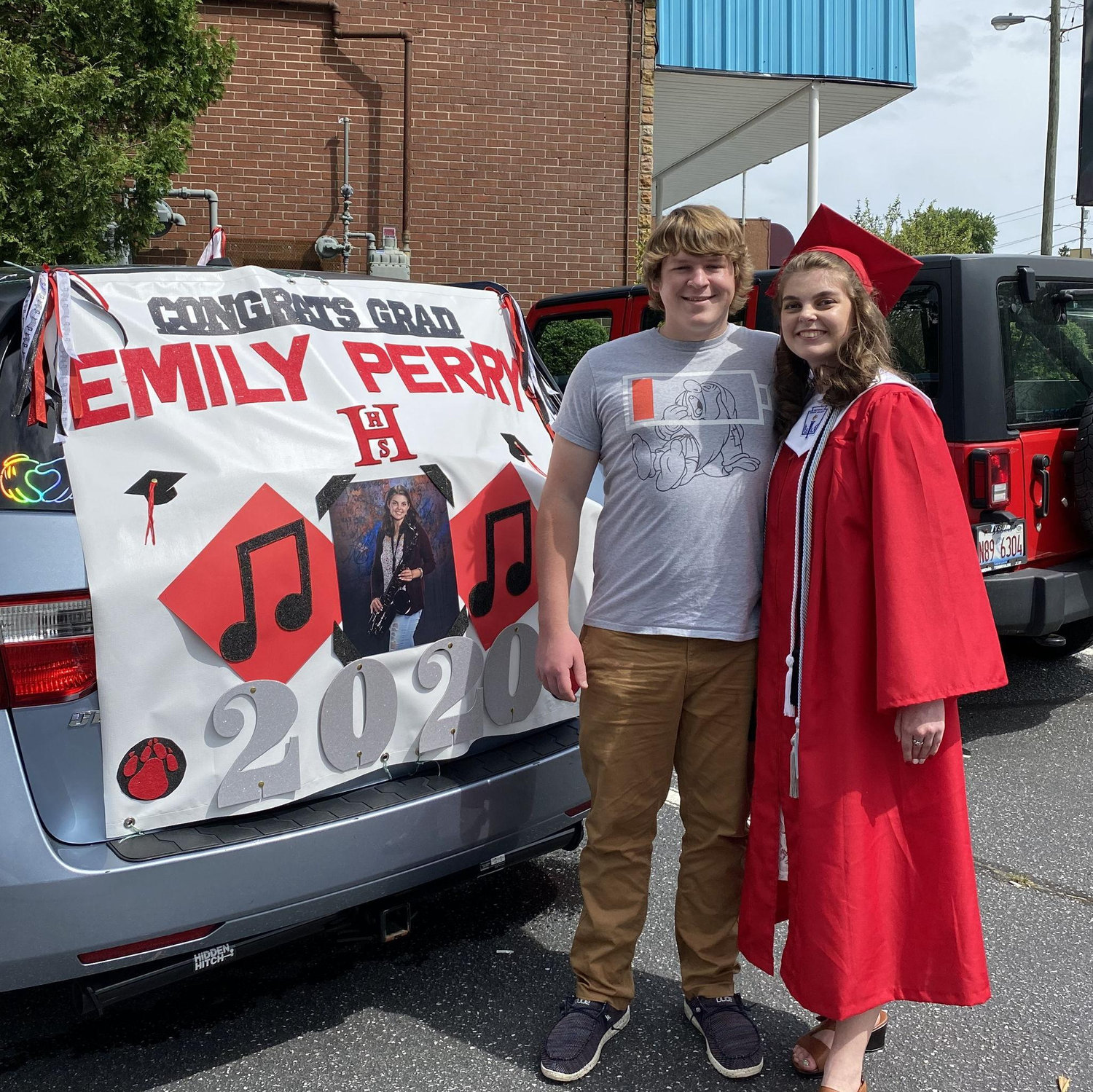 Emily graduated via drive-thru, and Zeke got to sit in the car with her while she received her diploma!