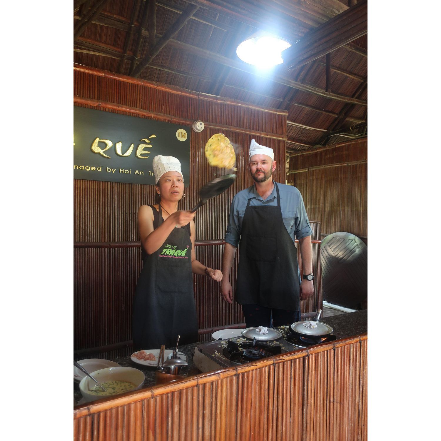 Us taking a cooking class outside Hoi An, Vietnam. Frances couldn't quite master the flip.