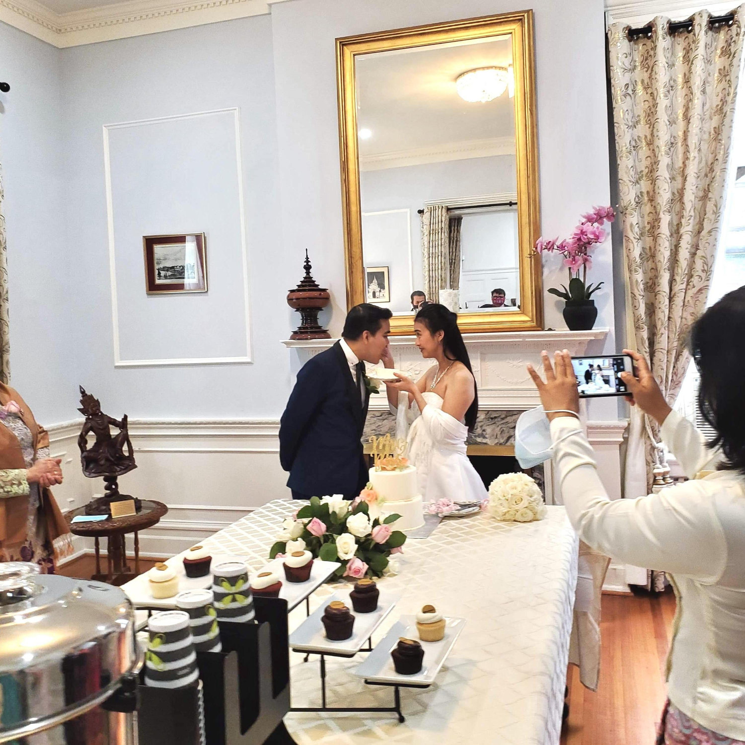 Bride and groom tasting their wedding cake.