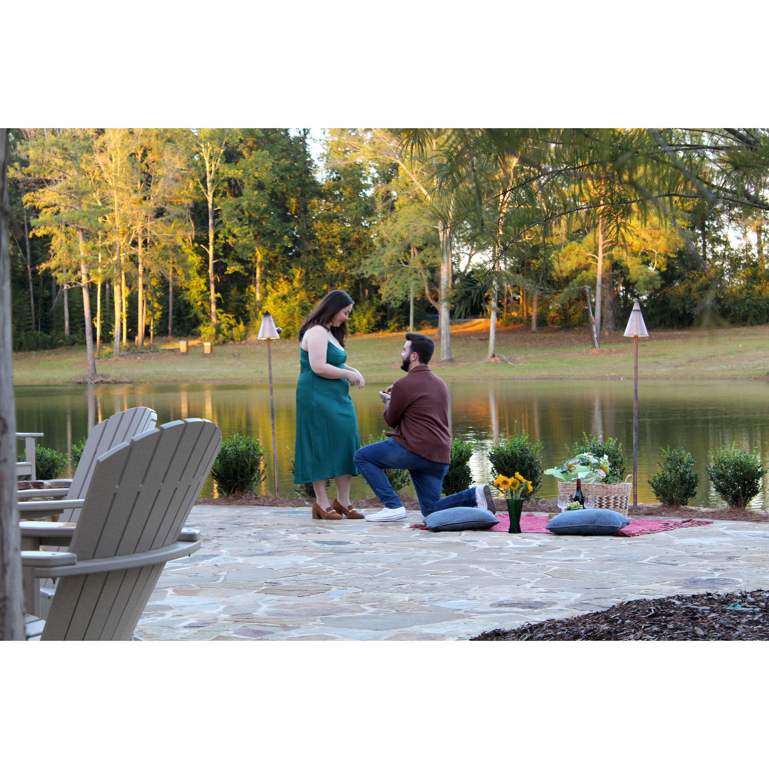 The moment Ethan proposed, during a stunning waterside picnic at Botanic in Opelika, AL.