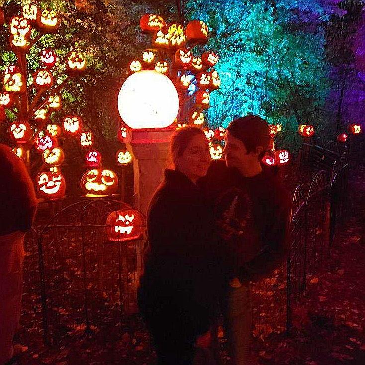 In front of a pumpkin that says "Will you marry me?"