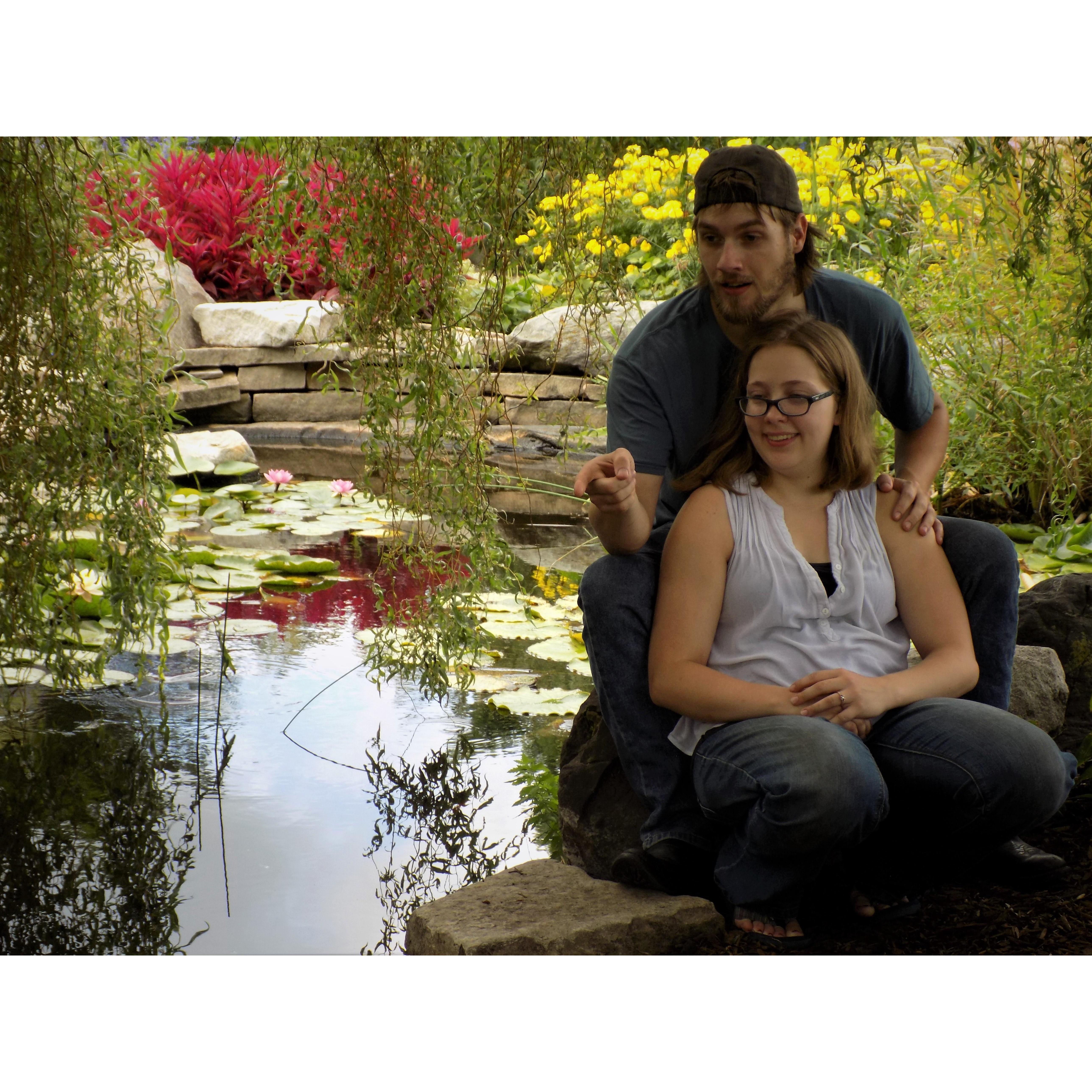 In this photo Micah was pointing out the gold fish swimming in the pond to Rebecca. It was a nice candid shot.