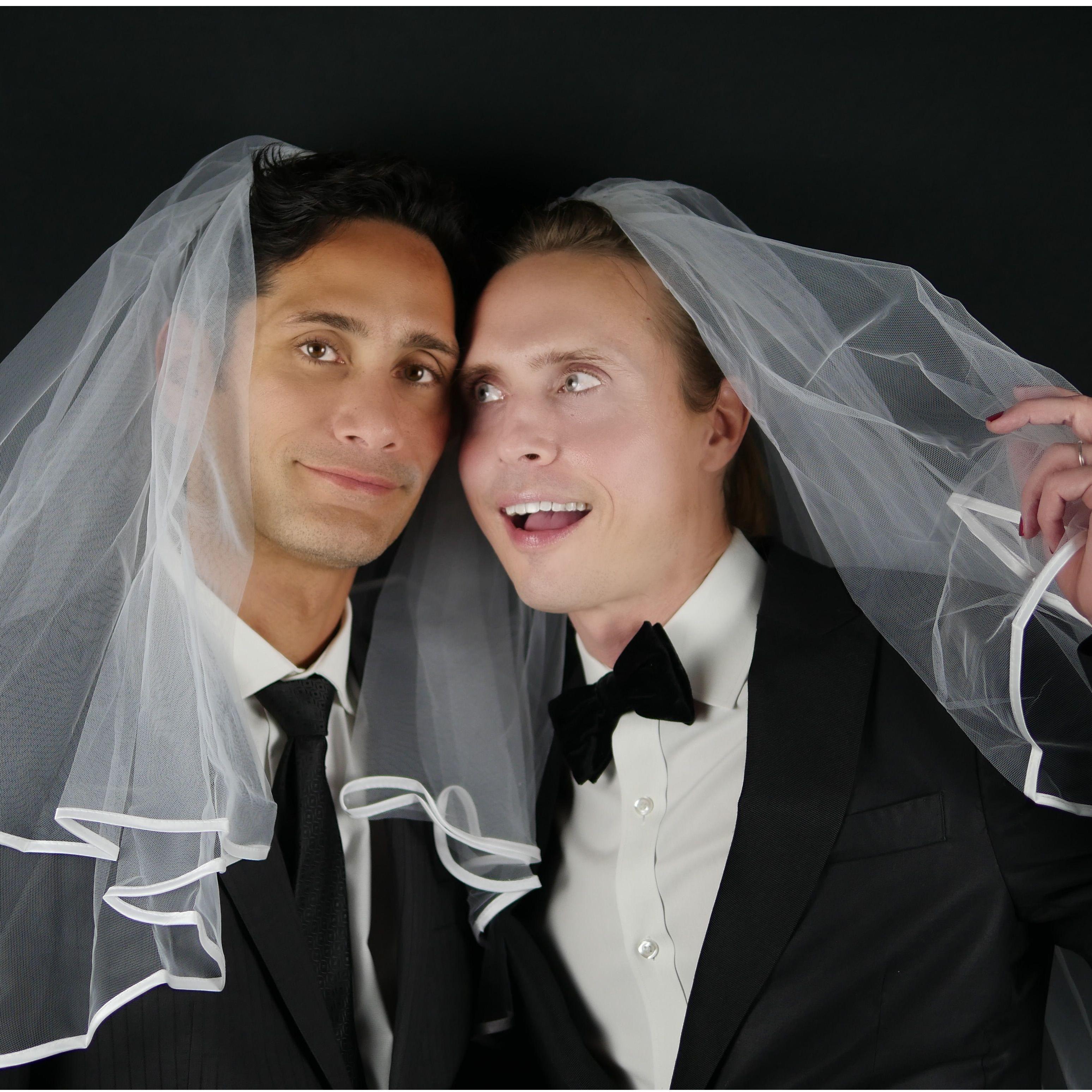 Engagement photo. Lane and John-Paul dressed up in black suits and white veils