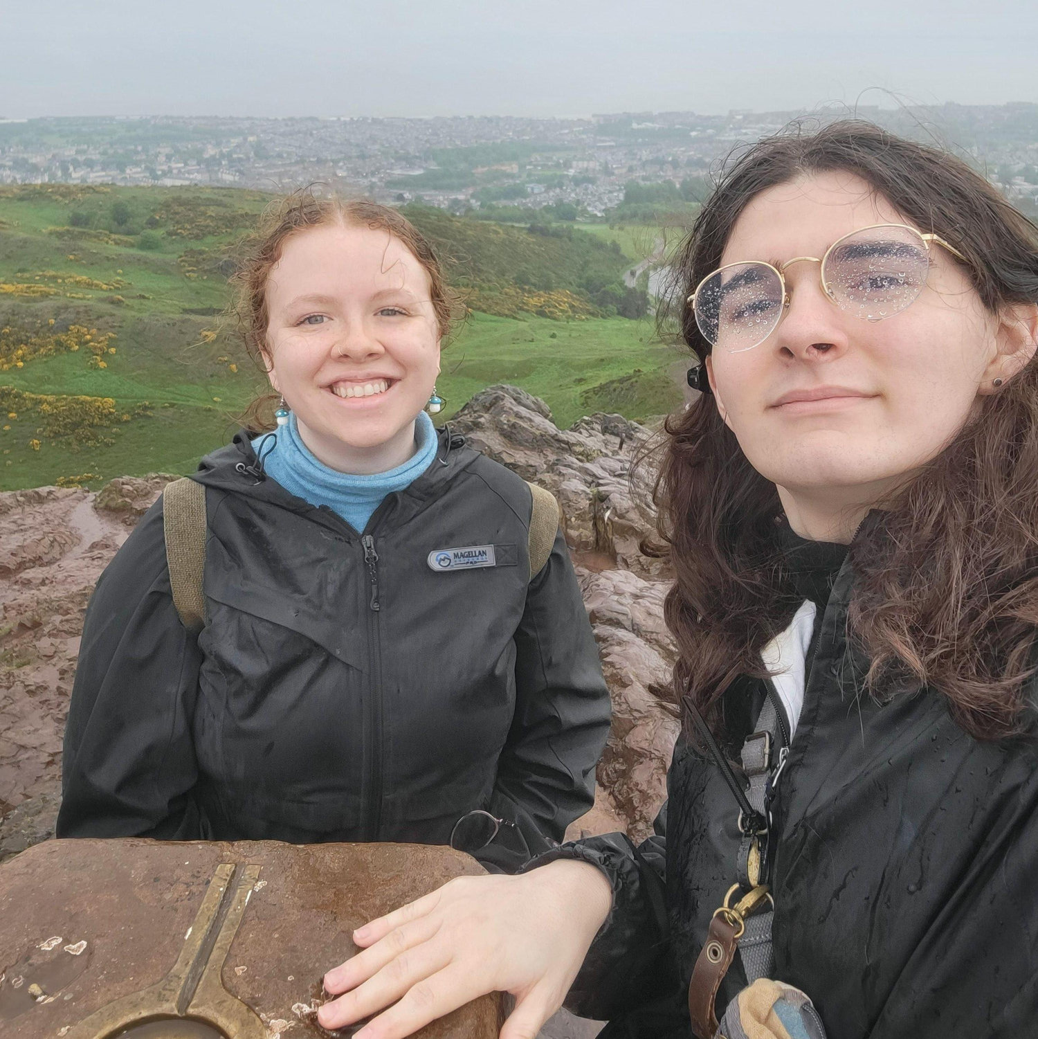 On top of Arthur's Seat in Edinburgh, Scotland. Joelle got sick the next day from this hike in the rain