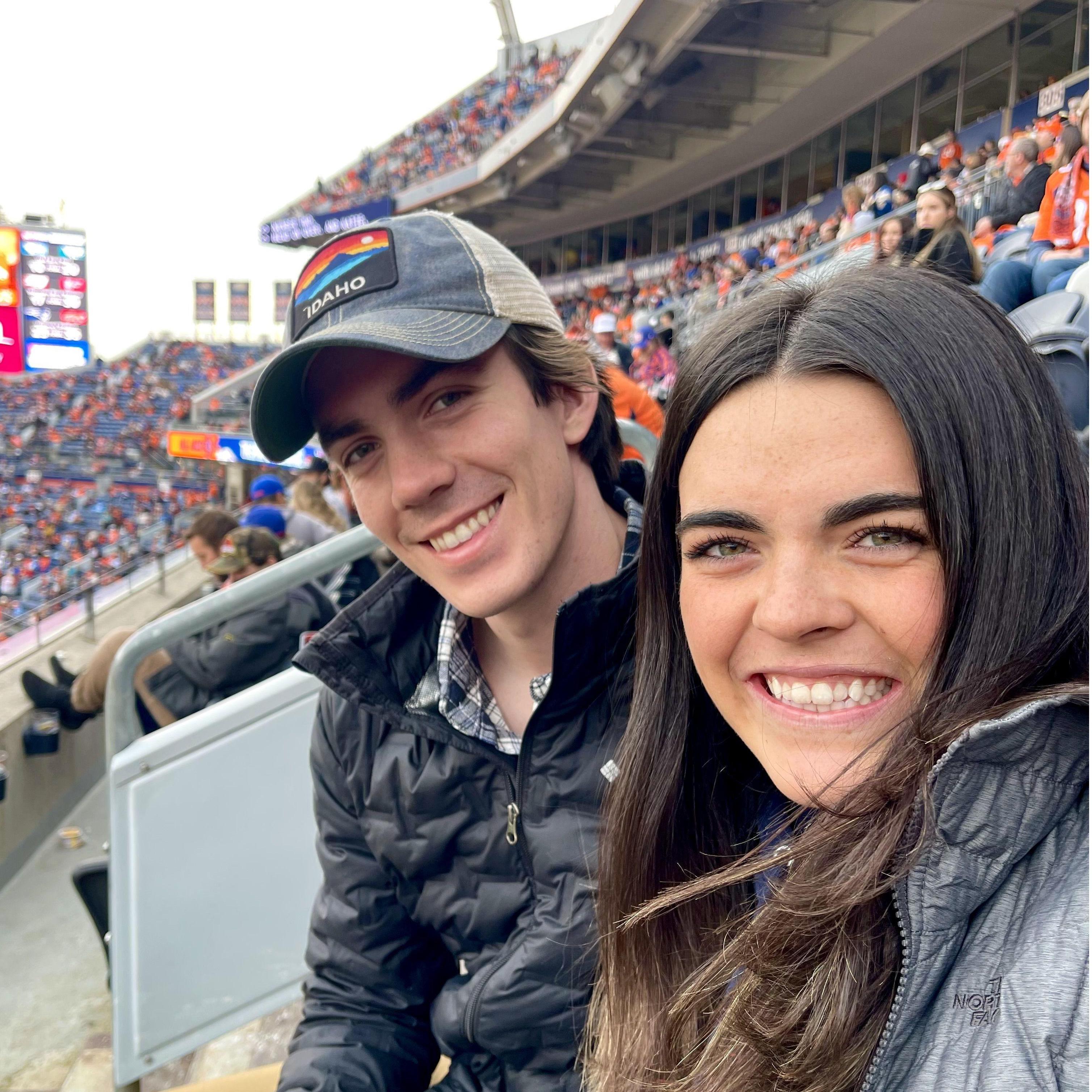 Abby and Alec's first NFL game (Penny not pictured). Watching the Broncos play tells Alec that Denver might be a pretty fun place to move!