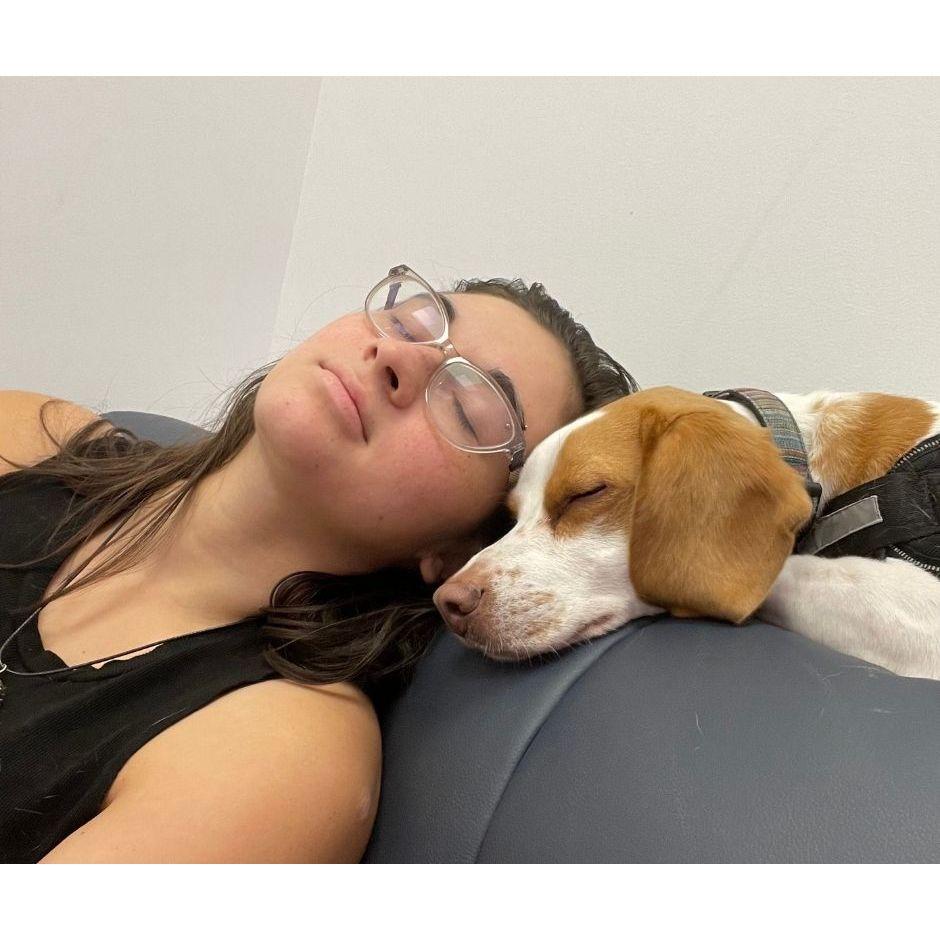 Norma asleep with Bagel at the vet