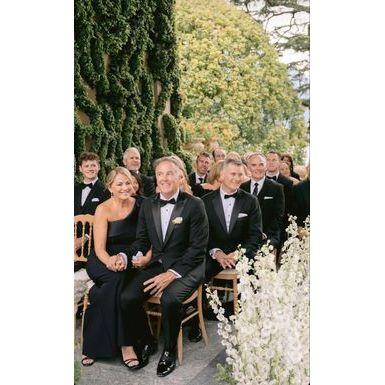 Classic black suits and tuxedos for gentlemen, paired with elegant gowns – the epitome of black-tie elegance.