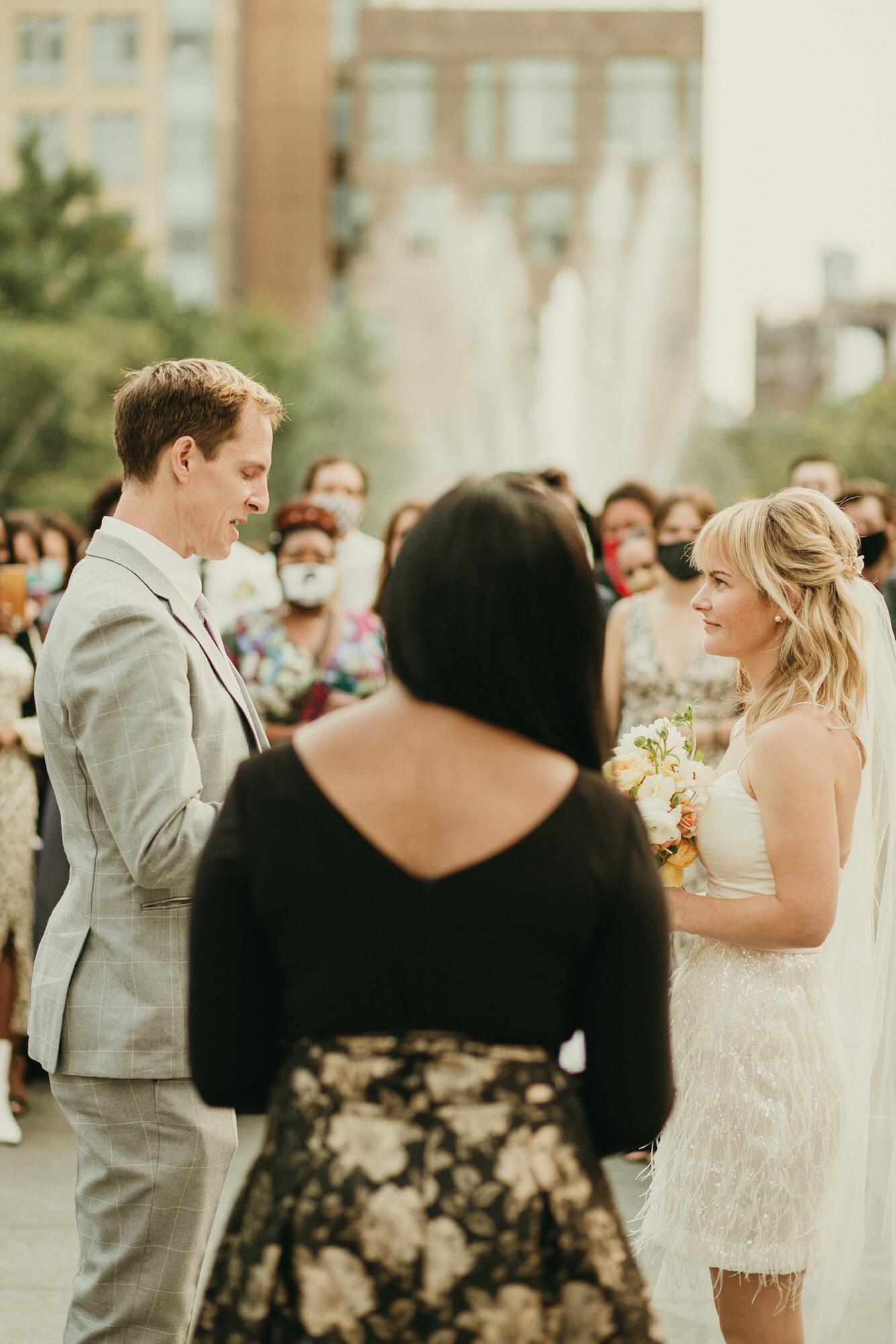 Andy reading his vows as our officiant Aretha Gaskin reminds him for the sixth time to make eye contact. Photo by @Purroy_Photo_Video