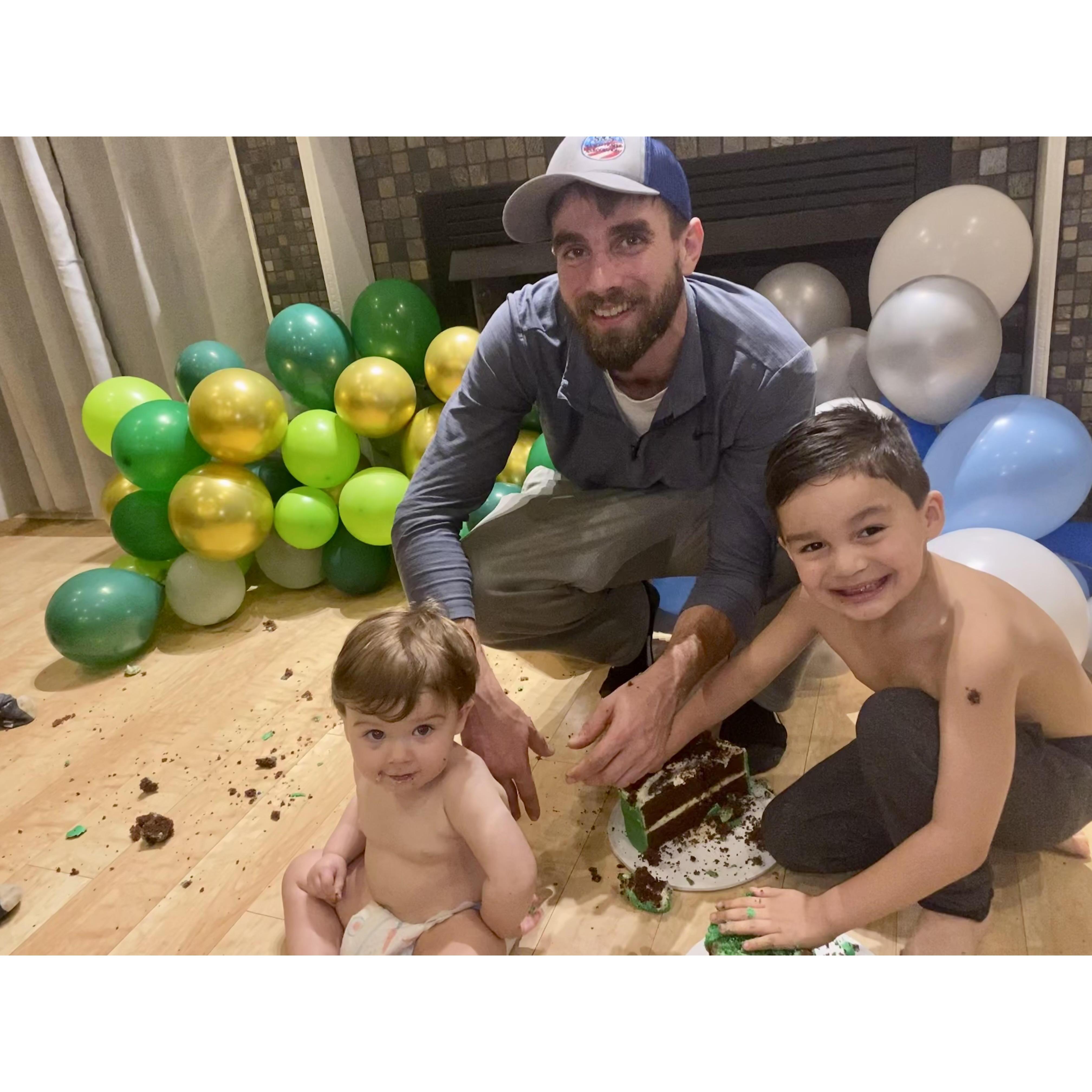 all the boys smashing cake after a fun 1st and 6th birthday party