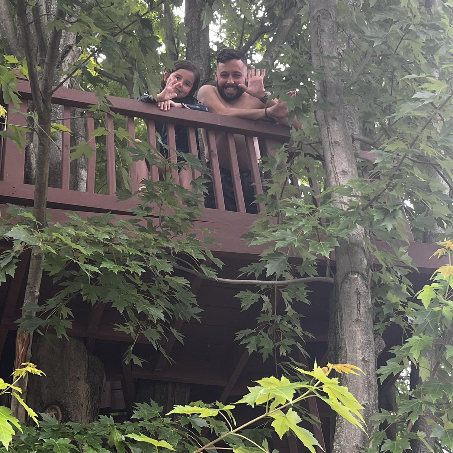 Chloe and Jeremy hanging out in a treehouse.