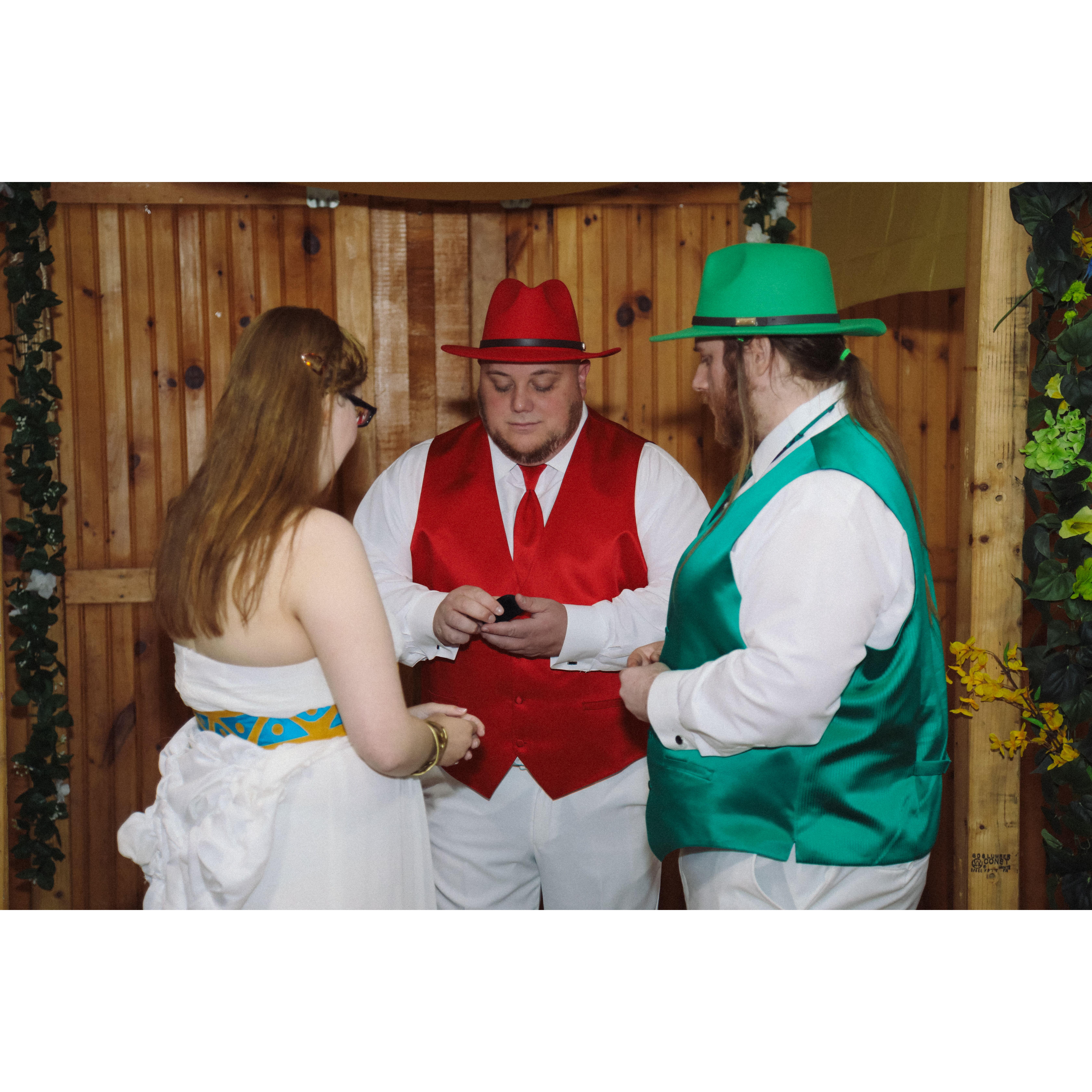 during the ceremony, Sara and Herb with Justin presenting the rings
