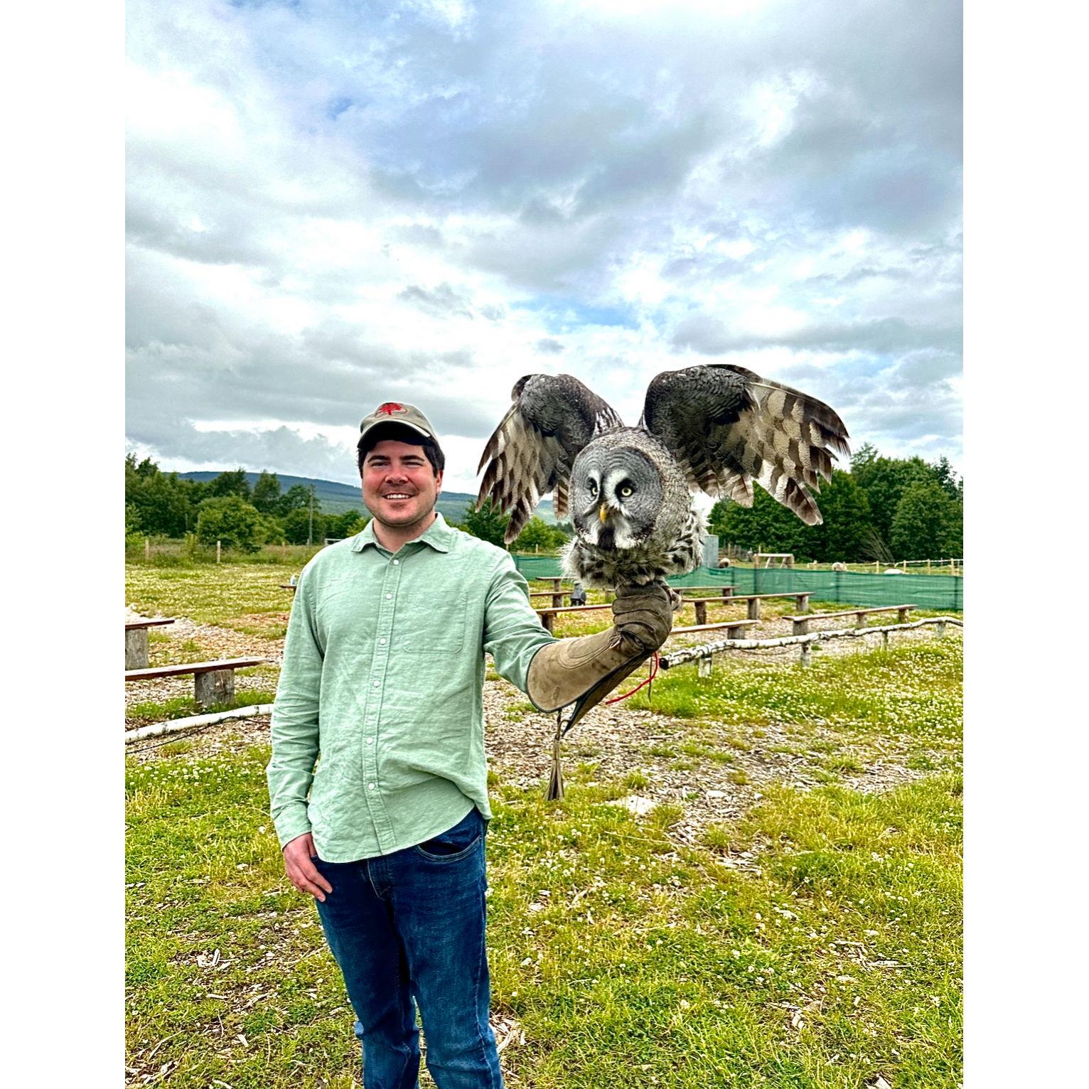 Alex holding a Barred Owl while taking falconry lessons in Aviemore, Scotland