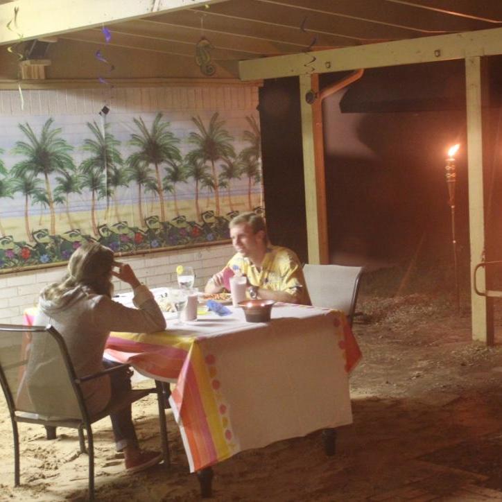 Lora and Nathan's first date (as captured by a roomate). Don't miss the tiki torches, beach backround, and sand that Nathan set up.