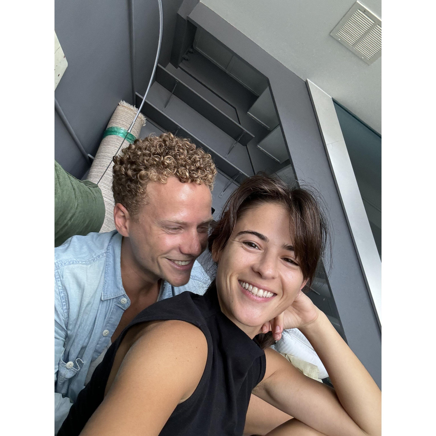 These are the smiles of two tired people who just moved into their first apartment together