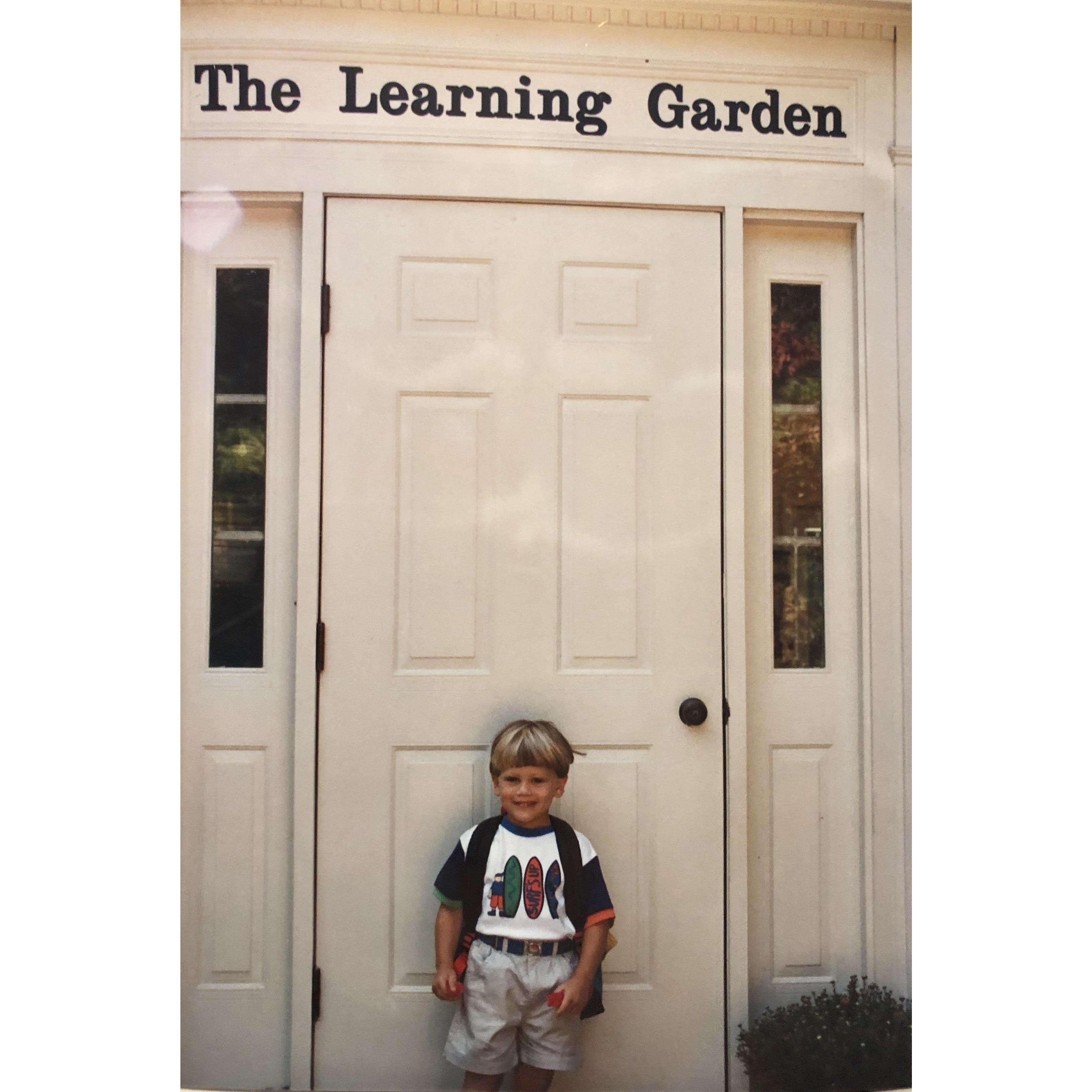 Dylan on the front steps of The Learning Garden where he proposed to Brittany!