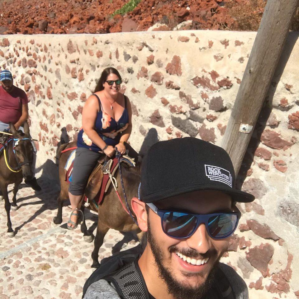 Riding donkeys up 300 steps from Ammoudi Bay to Oia, Santorini.