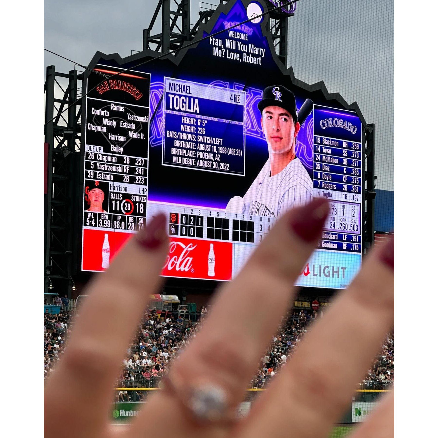Robert surprised Fran at a Colorado Rockies game by proposing on the Jumbotron!