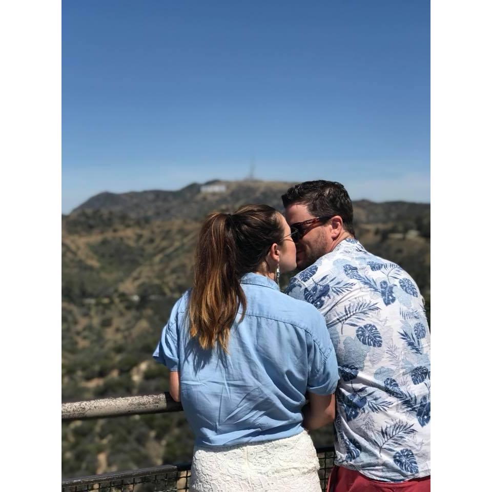 Stealing a kiss with a great view of the Hollywood sign