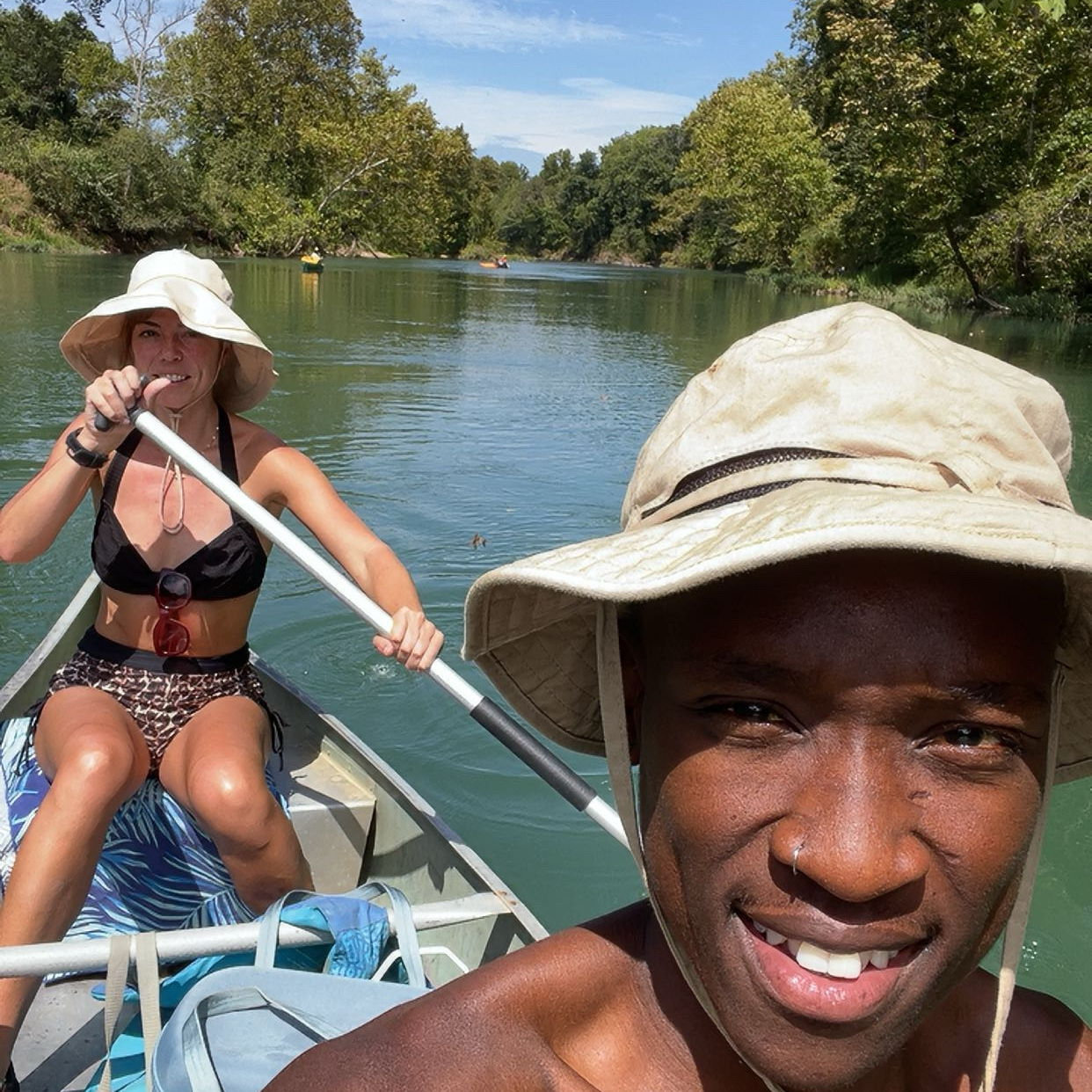 Kaitlyn paddles (the whole way) while Lindo takes selfies on his first float trip