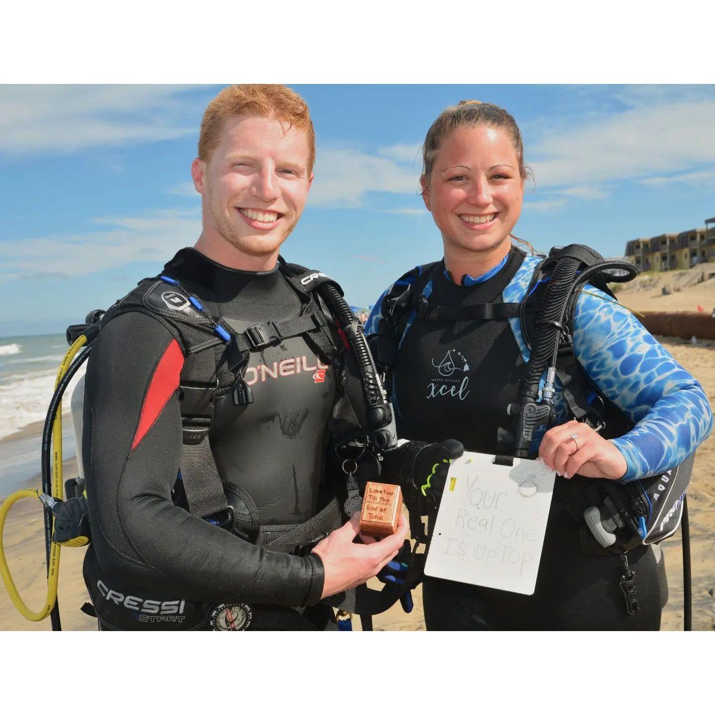 The sign Dakota proposed with under water when scuba diving in the outer banks North Carolina