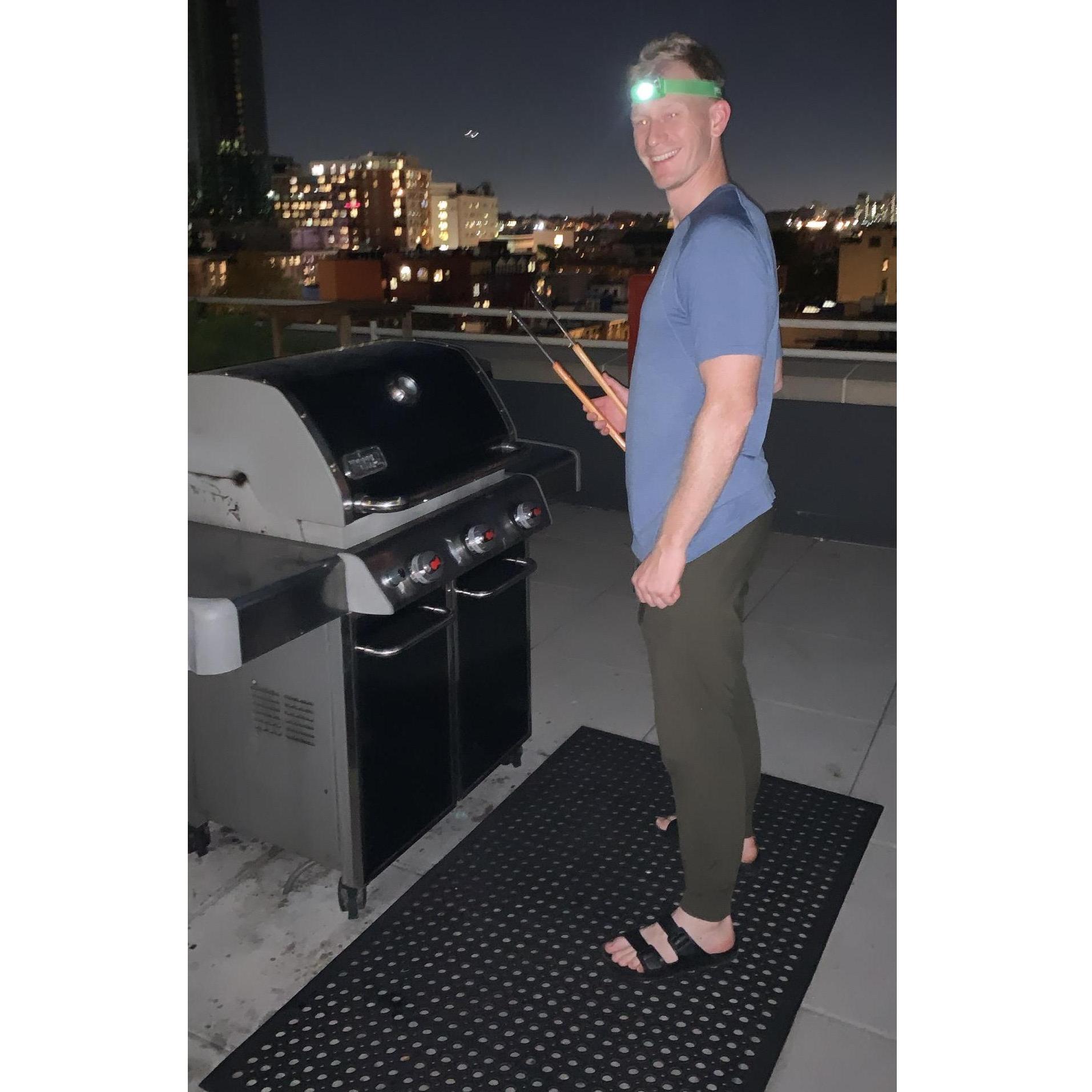 Andrew getting creative, grilling past sunset on our rooftop! September 2021