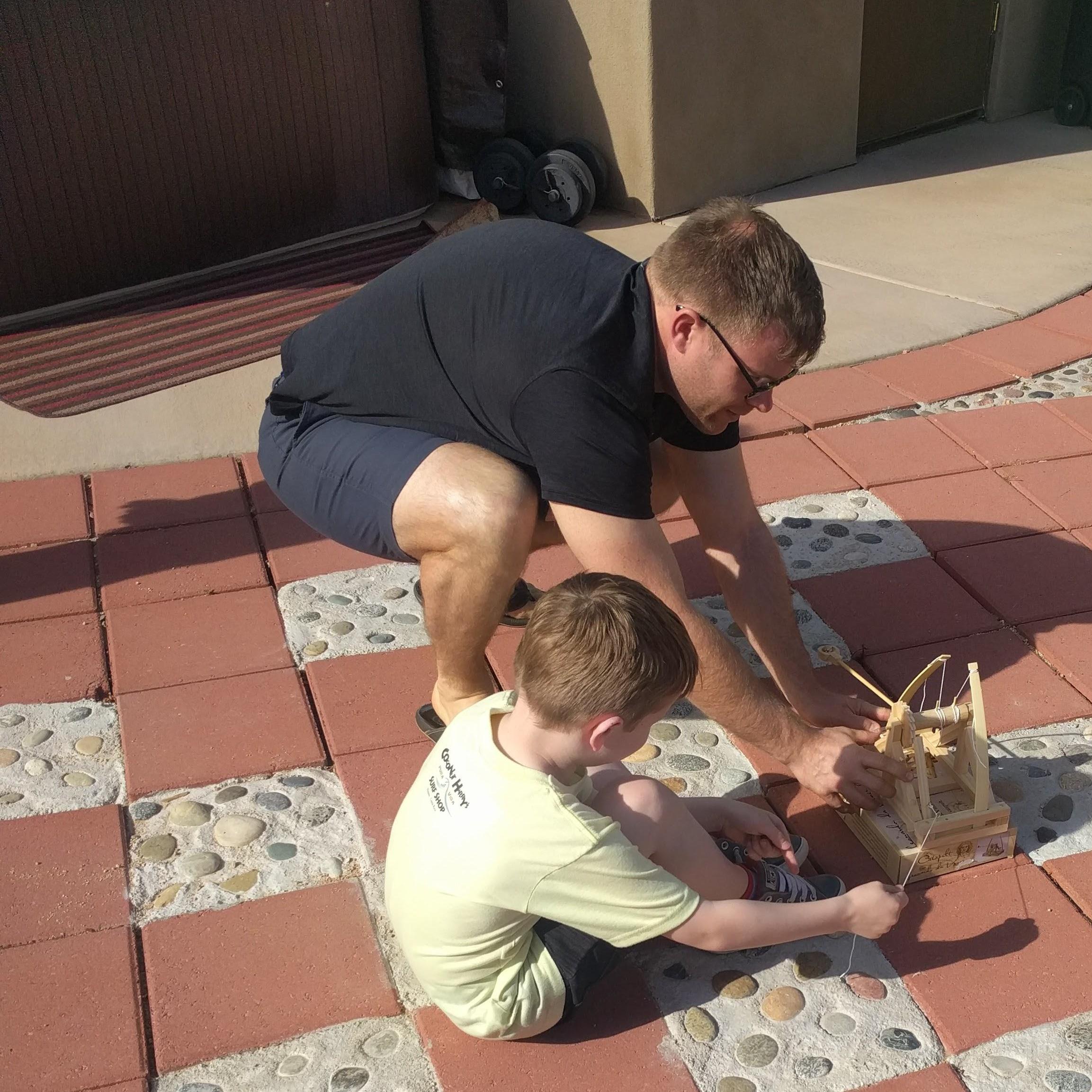 Max and Chase building a catapult