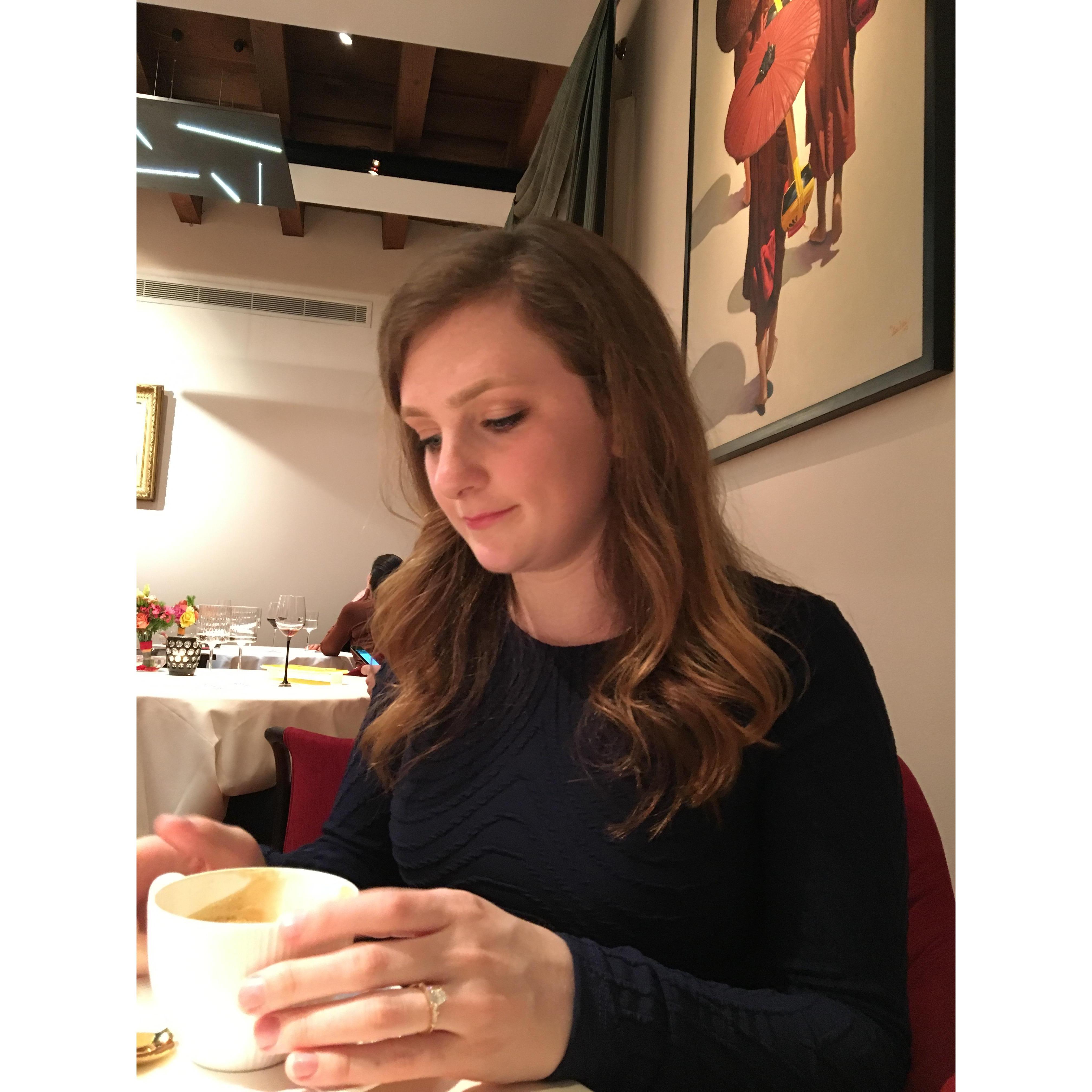 Kyle admiring her new engagement ring, while trying to enjoy her cappuccino after the 7 best courses of food we have ever eaten.