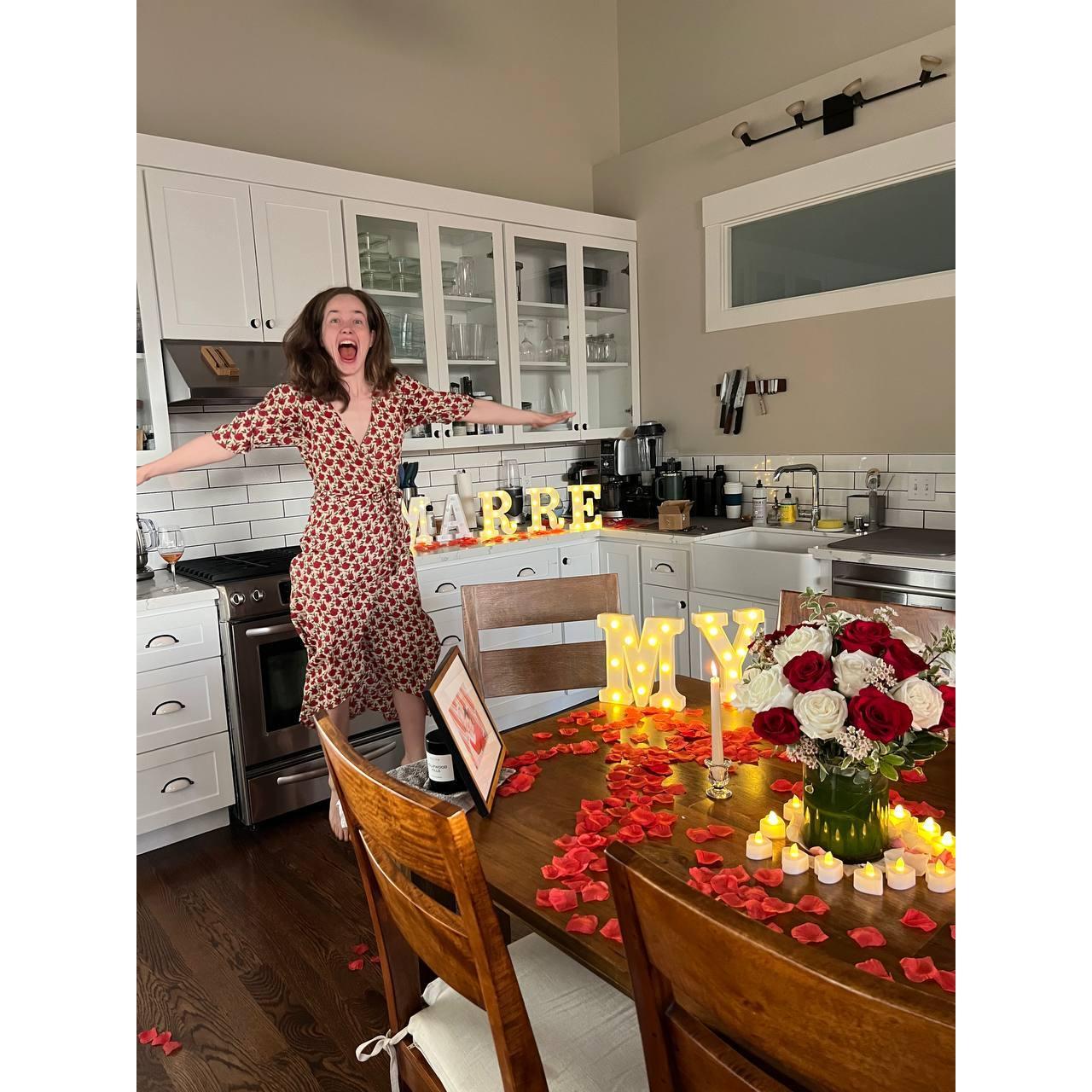 Jake proposed in our candlelit flower-covered apartment! Anne jumped with Yes.