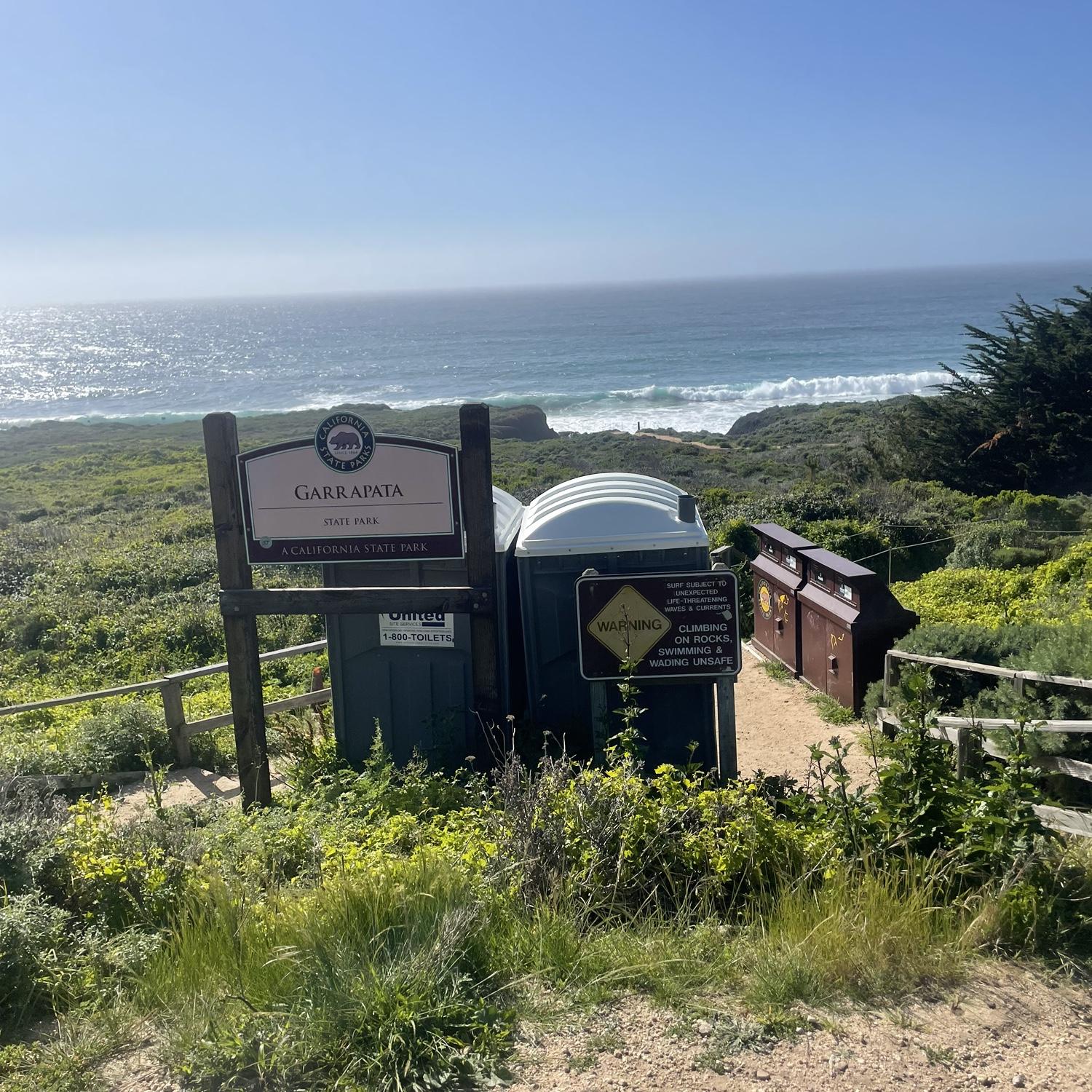 Please find this area as it is the start of the trail to our ceremony area! Parking is right to the side of this area on either direction, in the dirt areas right off the side of the road!