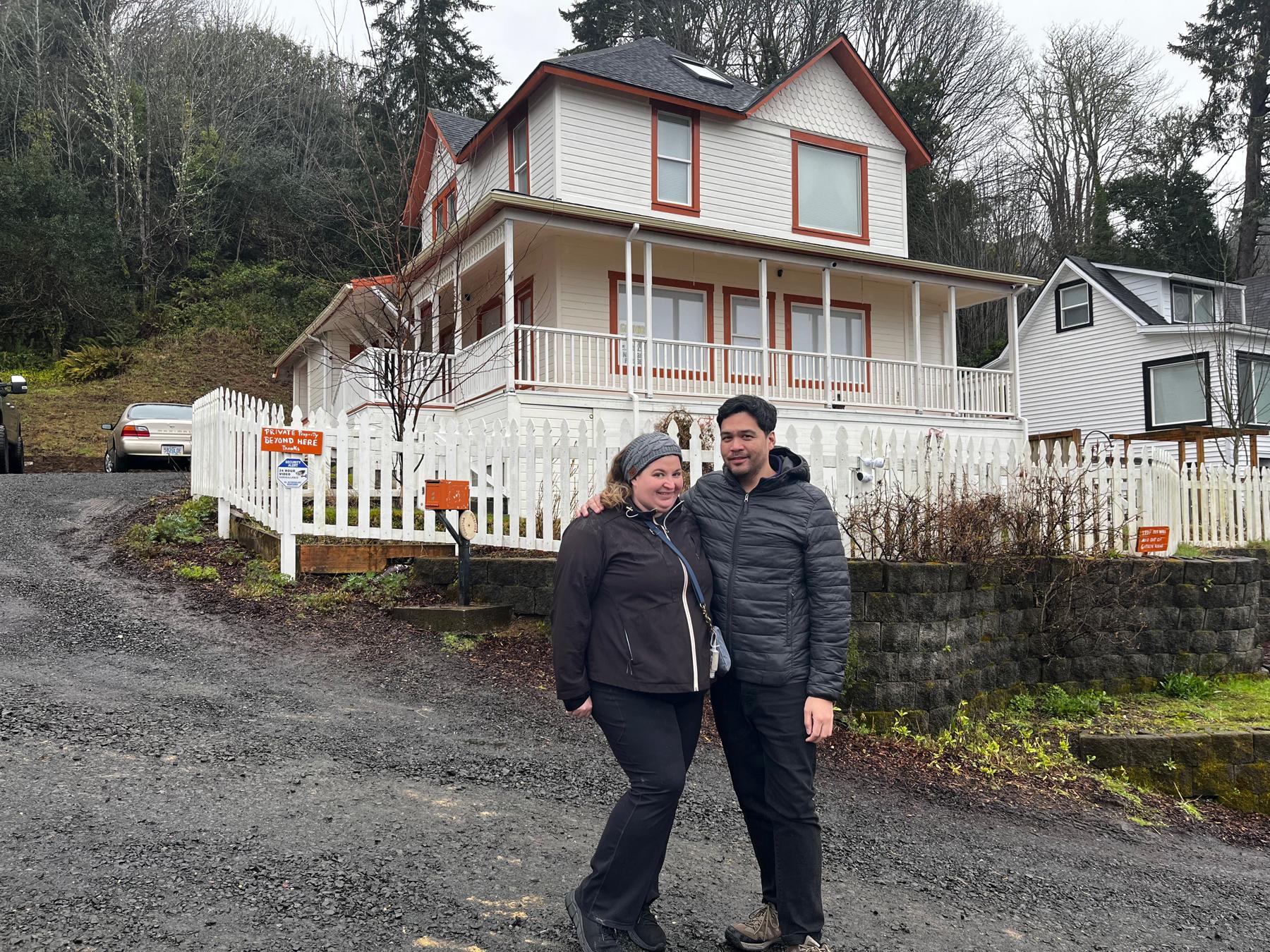 Sarah and Carlo in Astoria in front of the iconic Goonies house.